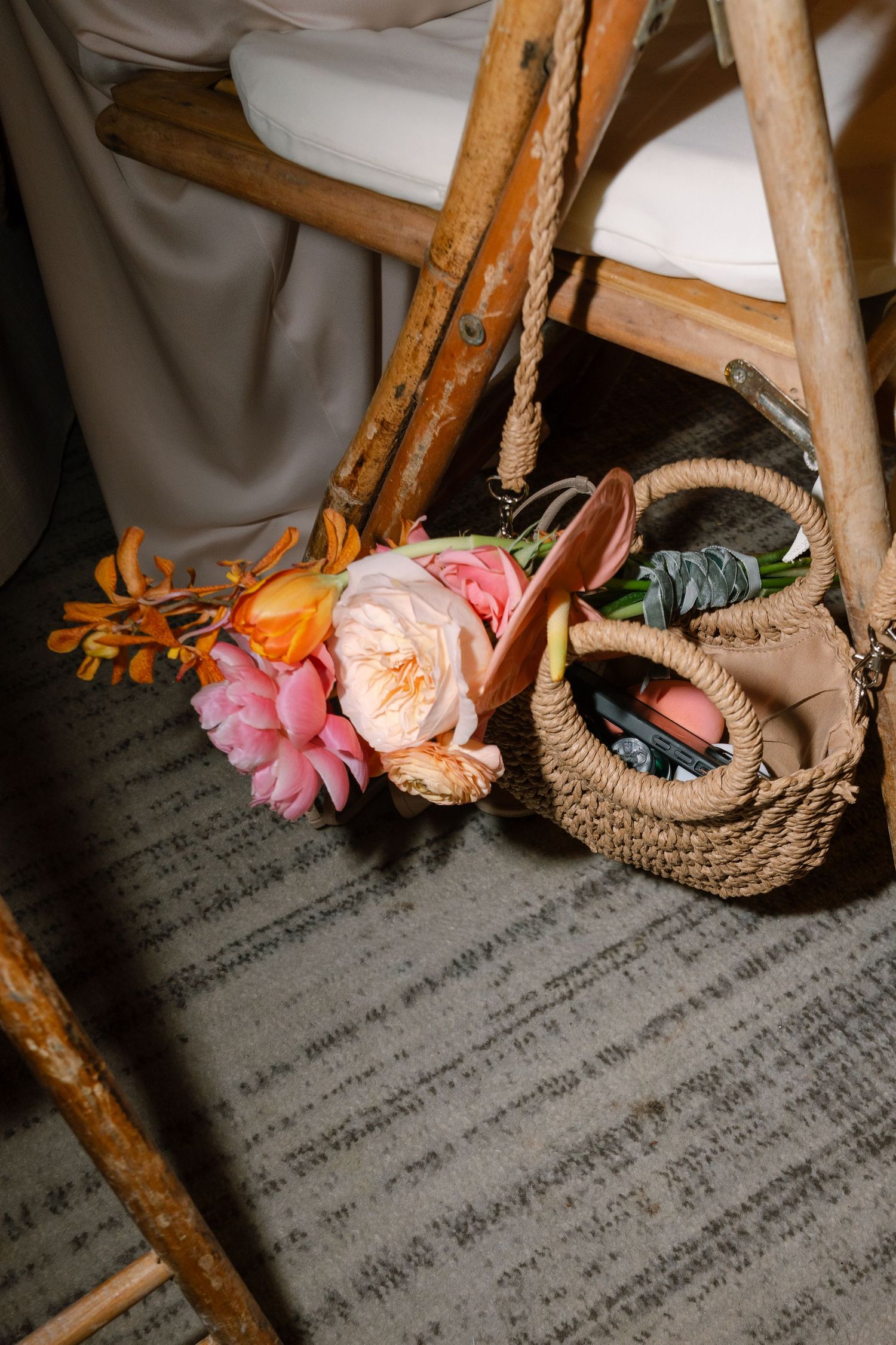 Vintage wooden chairs decorated with delicate pink and orange flowers.