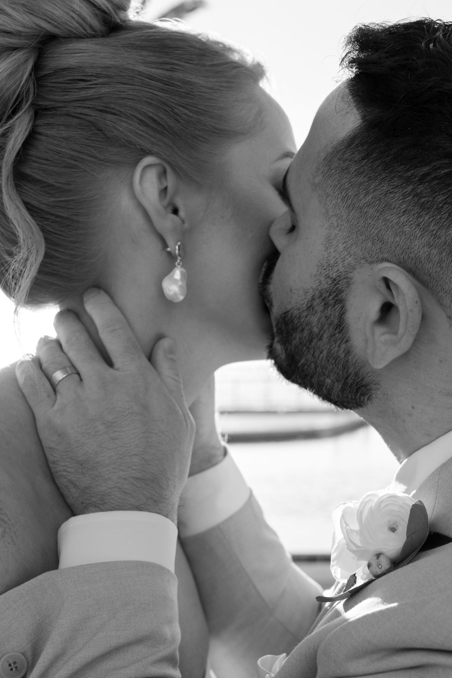 Intimate black and white close-up of a romantic moment between newlyweds.