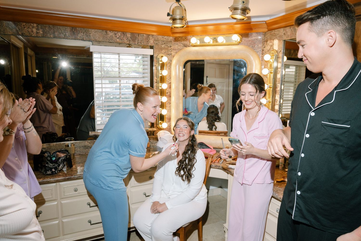 A group of people gathered in a room, some dancing and celebrating together.