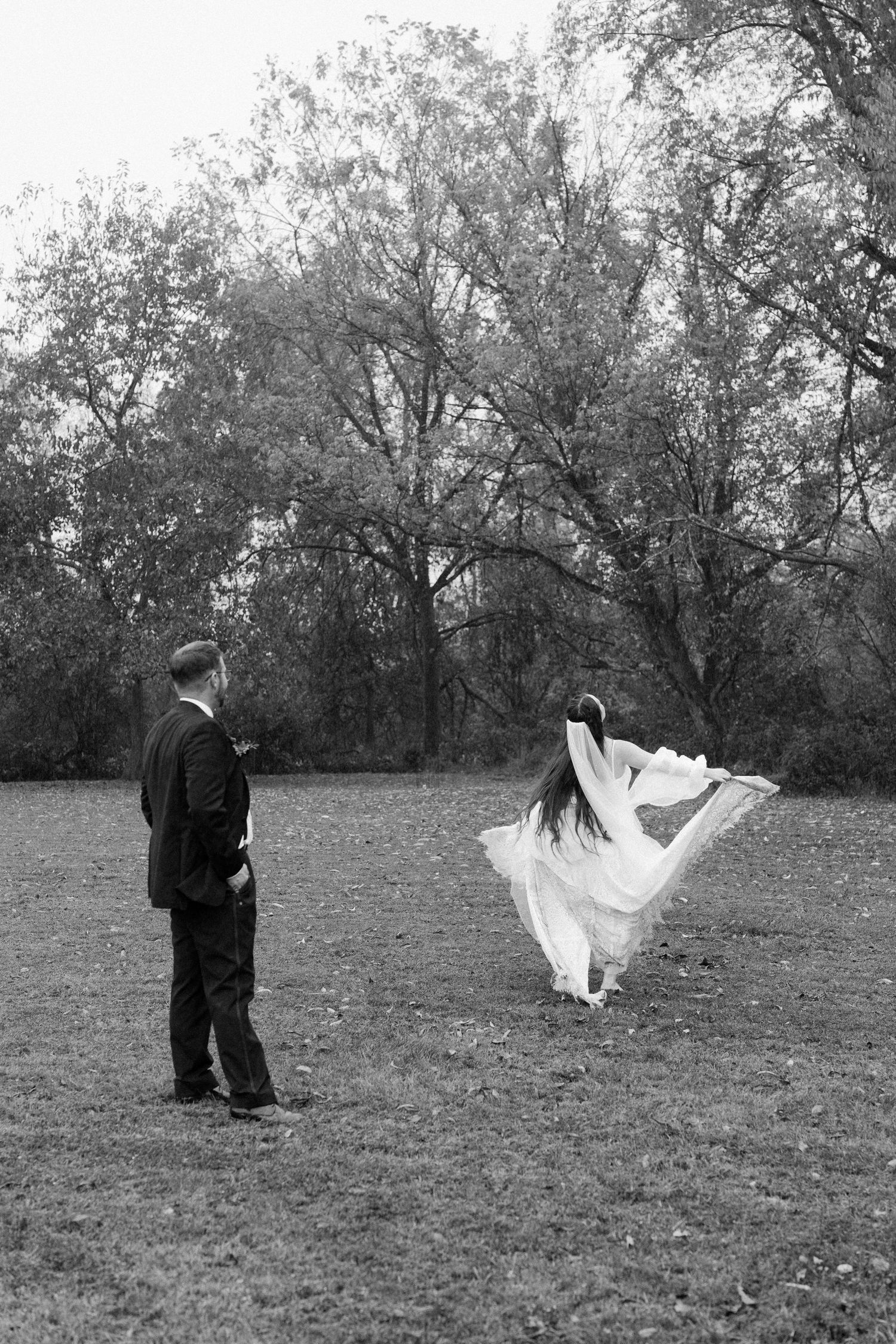 A black and white sequence of wedding photos capturing a couple's playful dance movements in a rustic outdoor setting.