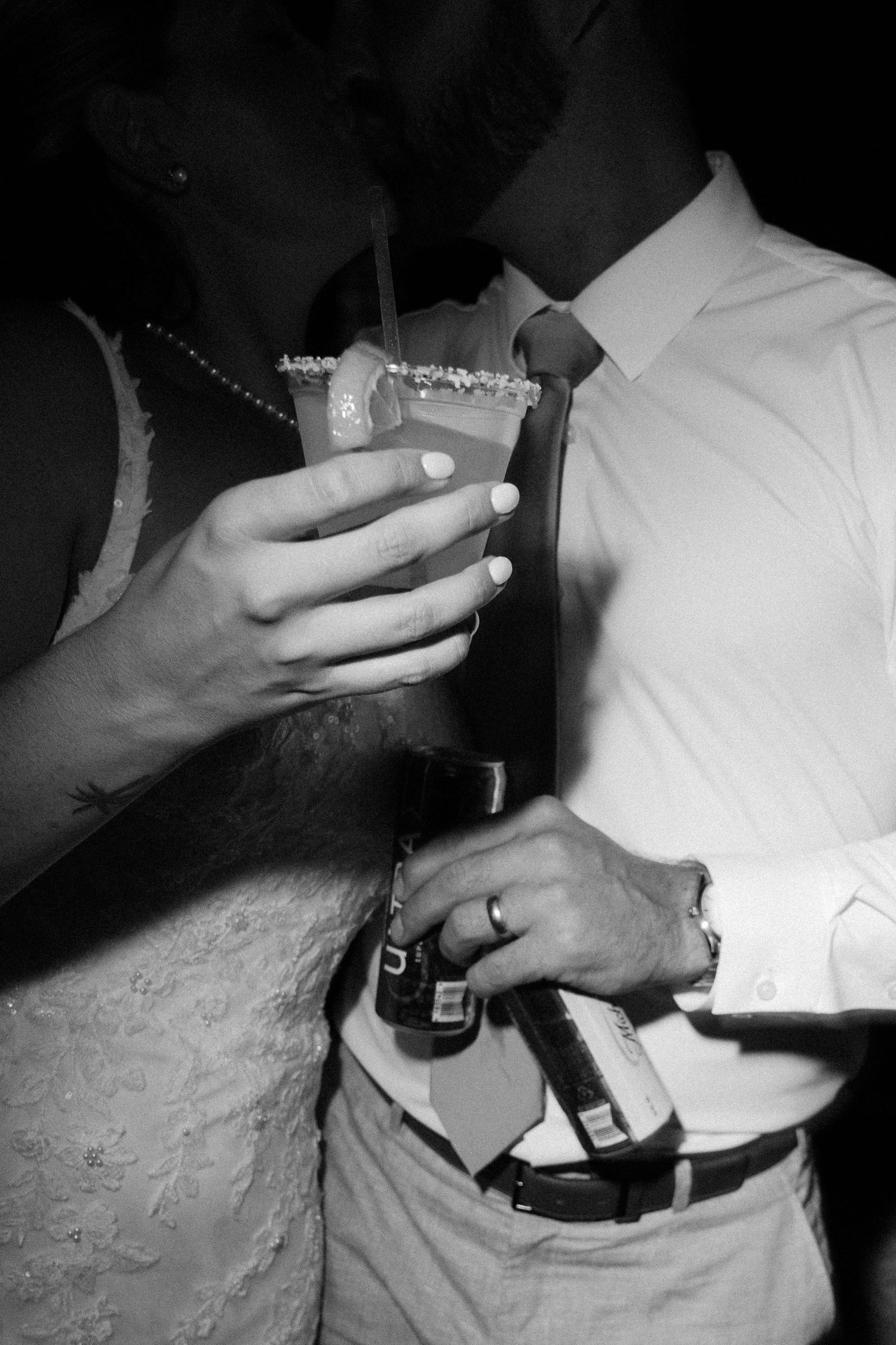 Black and white close-up sequence showing hands adjusting formal attire.