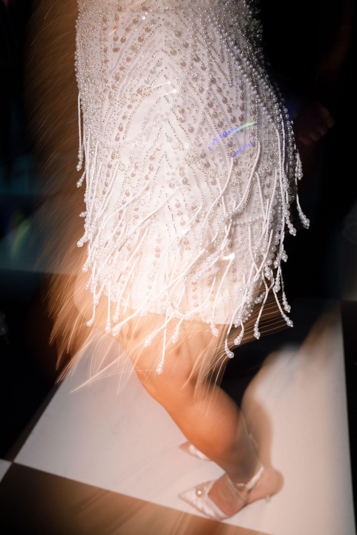 Abstract close-up shots of crystal chandelier details creating ethereal white patterns against dark background.