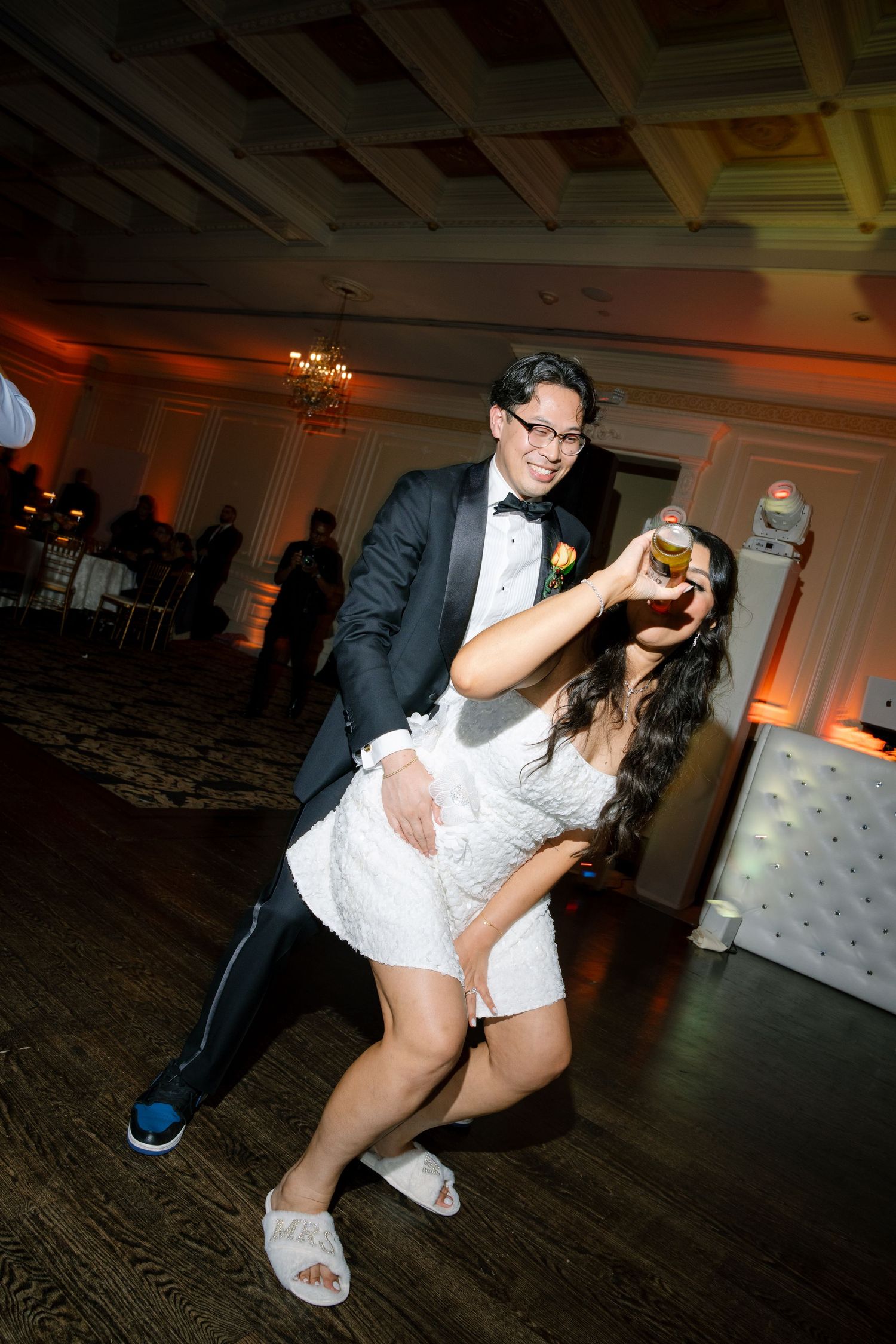 A playful wedding dance moment captured on the reception dance floor.