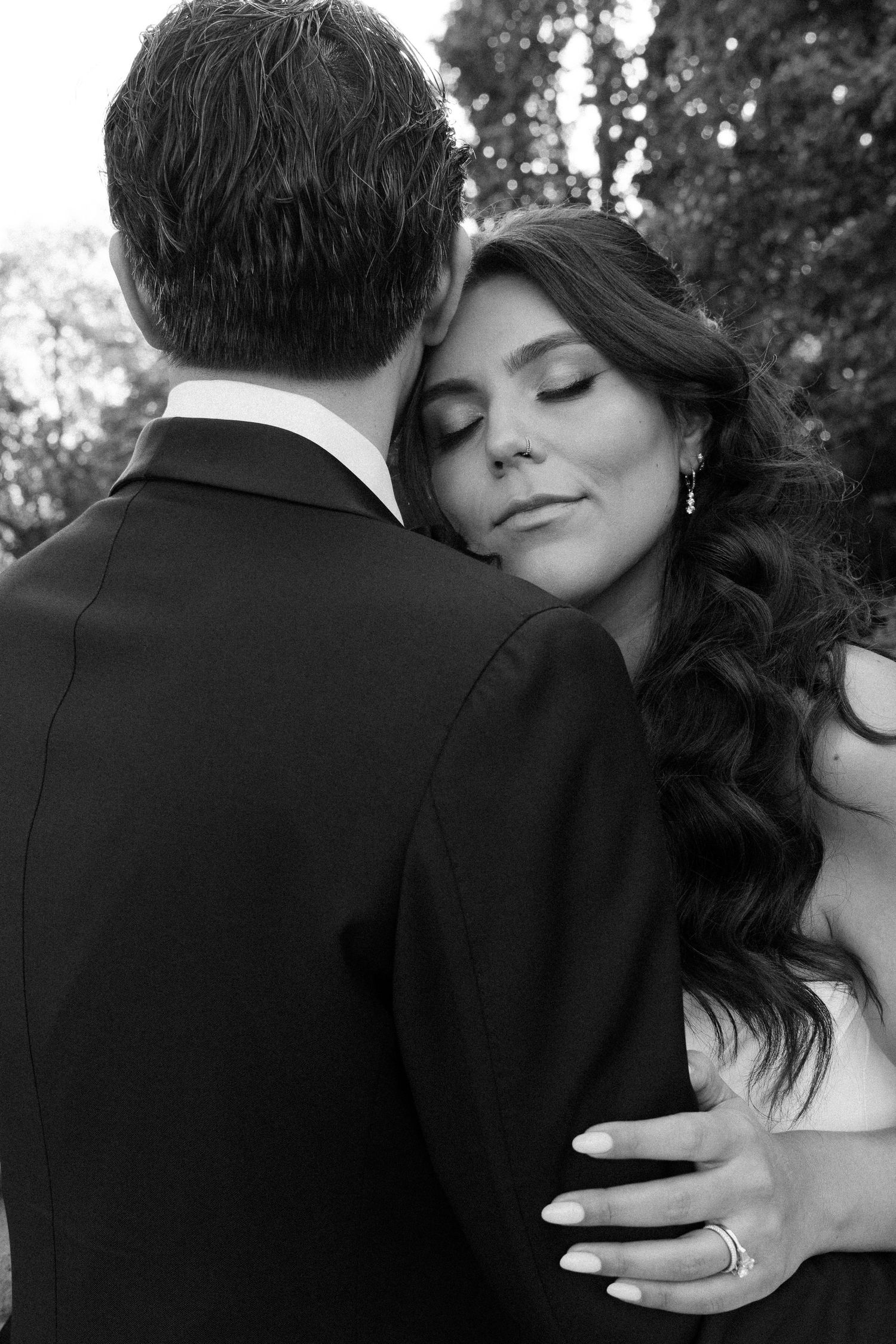 Intimate black and white wedding portrait showing tender embrace.