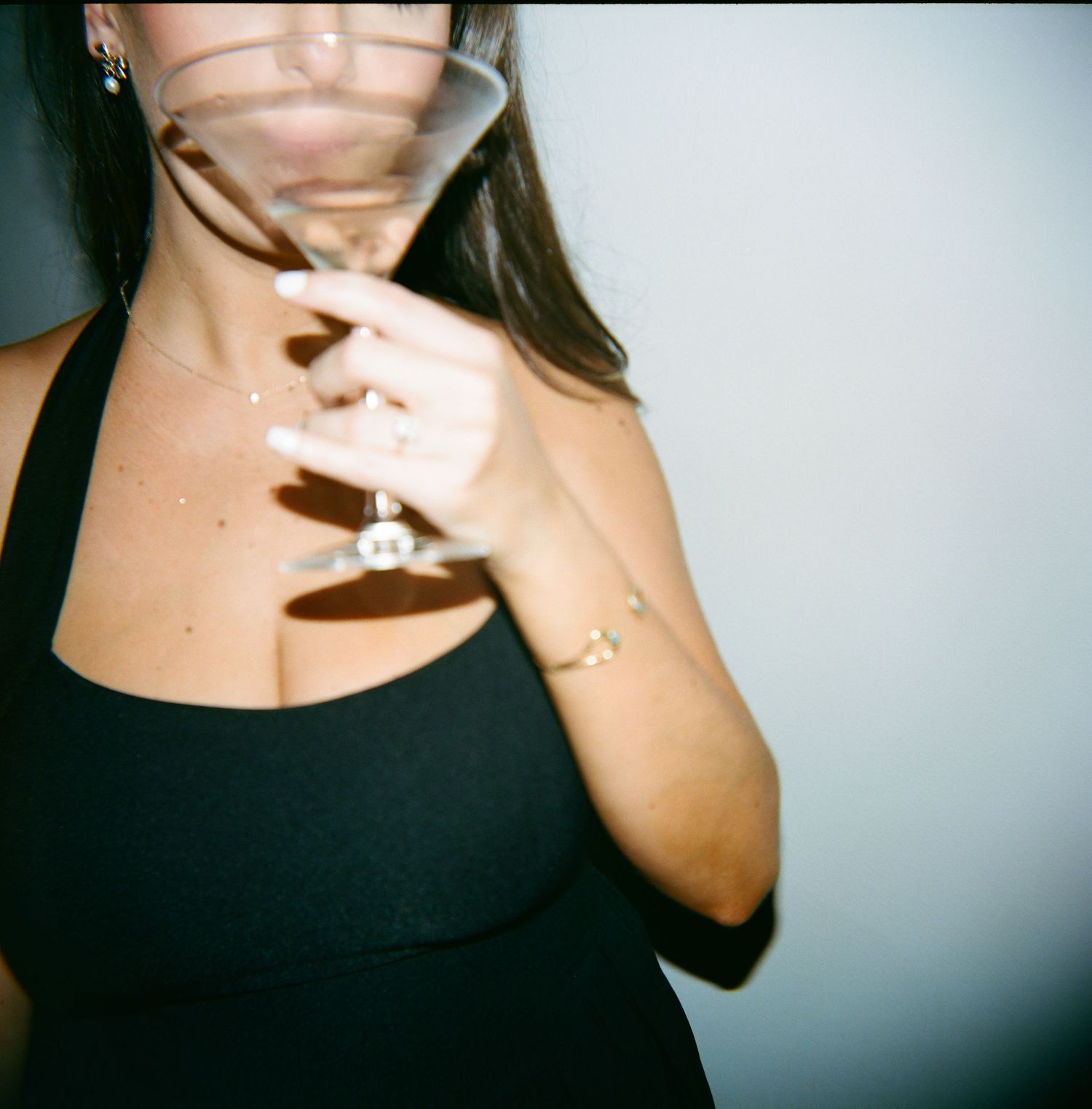 Person in black top posing in multiple cropped portrait shots against light background.