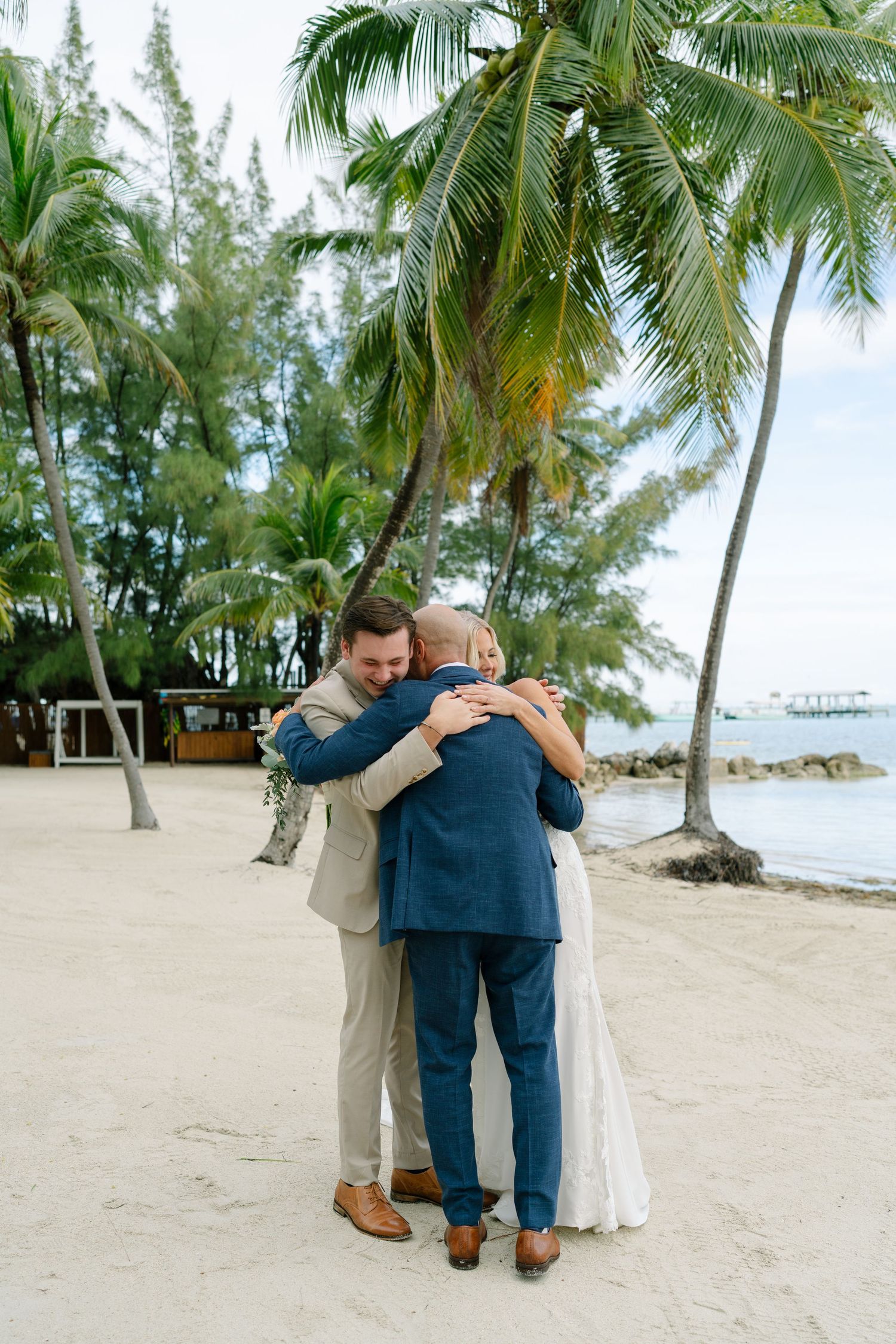 Series of romantic beach wedding photos with palm trees showing couple embracing on sandy tropical shore.