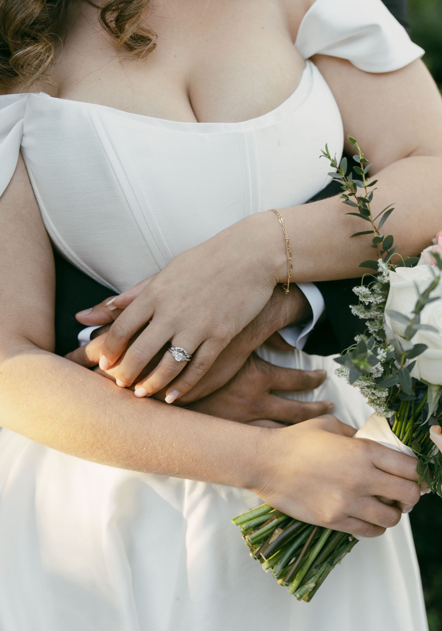 Close-up shots of elegant hands holding a wedding bouquet showing a diamond engagement ring.