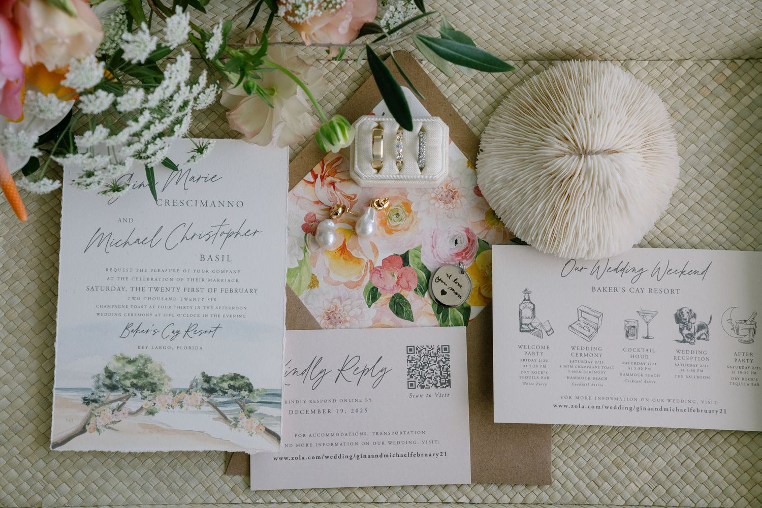 Wedding invitation suite with floral design, timeline card, and RSVP details laid out with fresh flowers and decor.