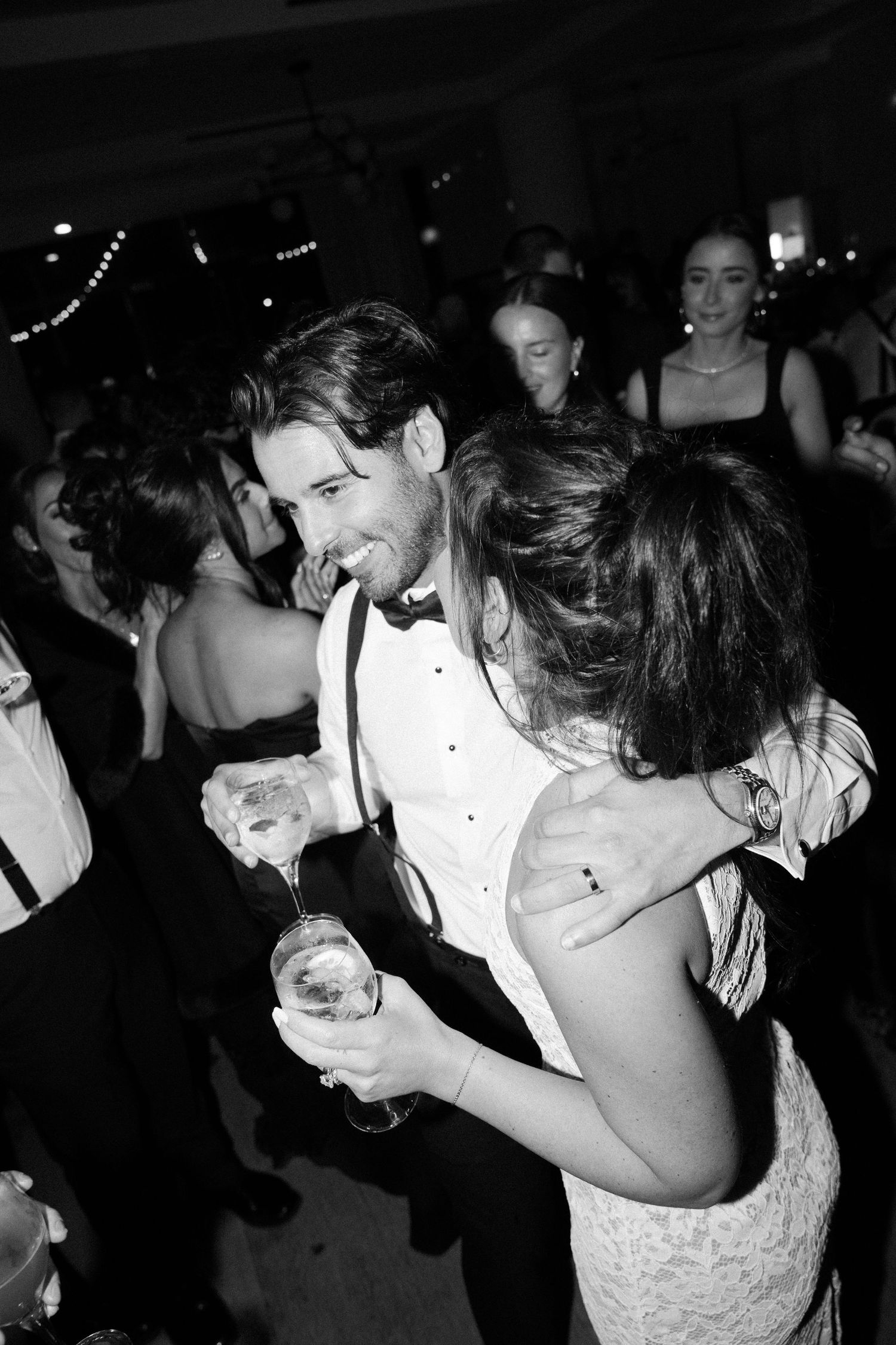 Guests dancing and celebrating together at an elegant evening wedding reception.