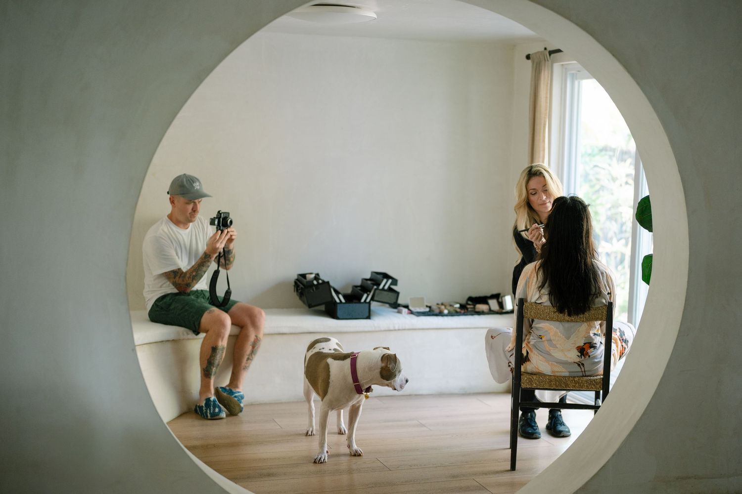 A sequence of photos showing a dog and person practicing yoga poses together in a bright indoor space.