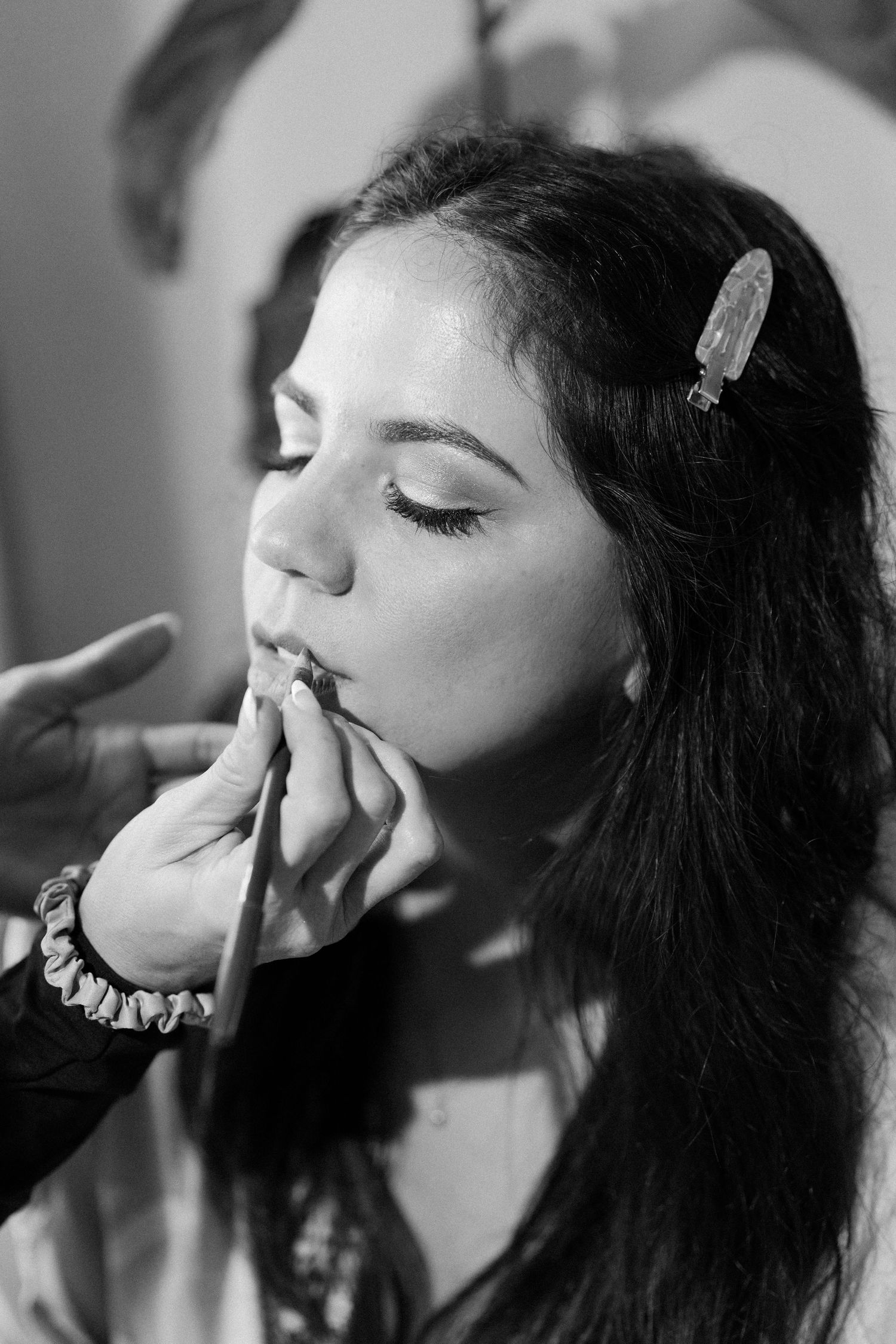 Black and white artistic portraits showing a person smoking in a sequence of dramatic close-up shots.