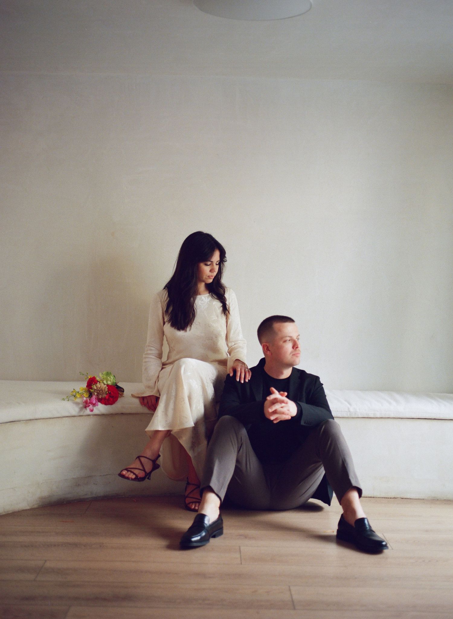 Artistic photo sequence showing couple in minimalist white room setting.
