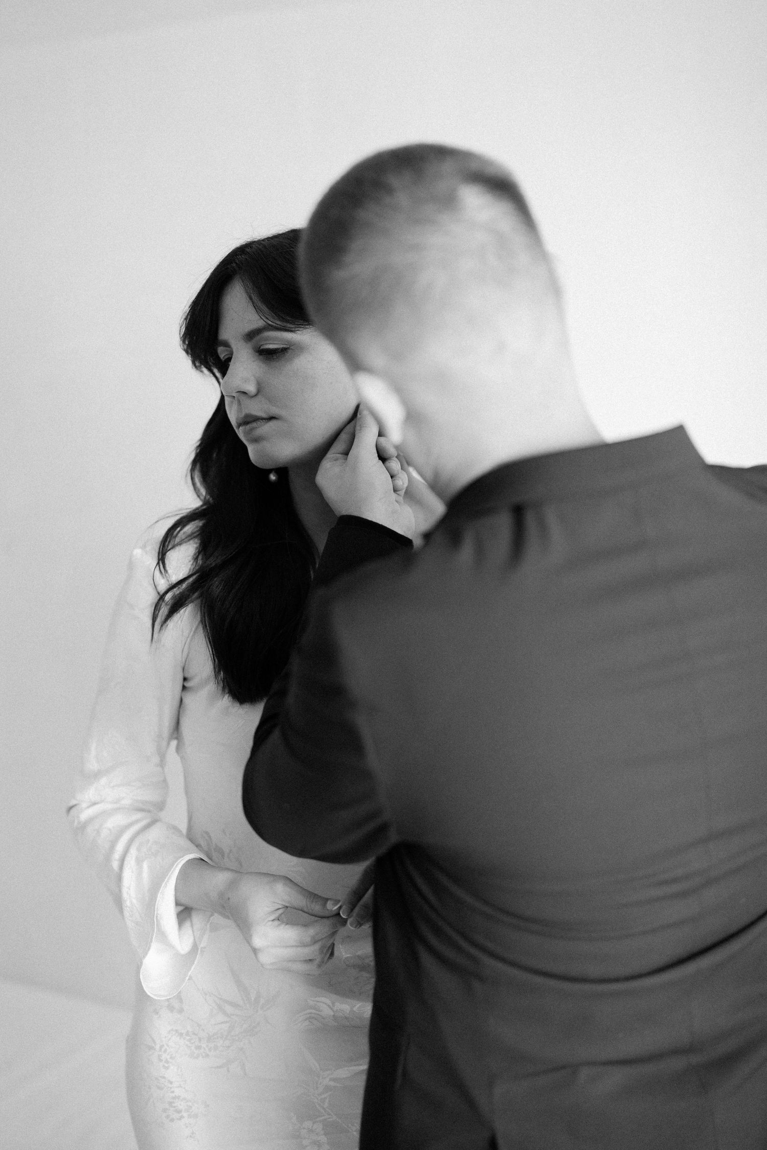 A romantic black and white photo sequence shows a couple in wedding attire leaning in for a tender moment.
