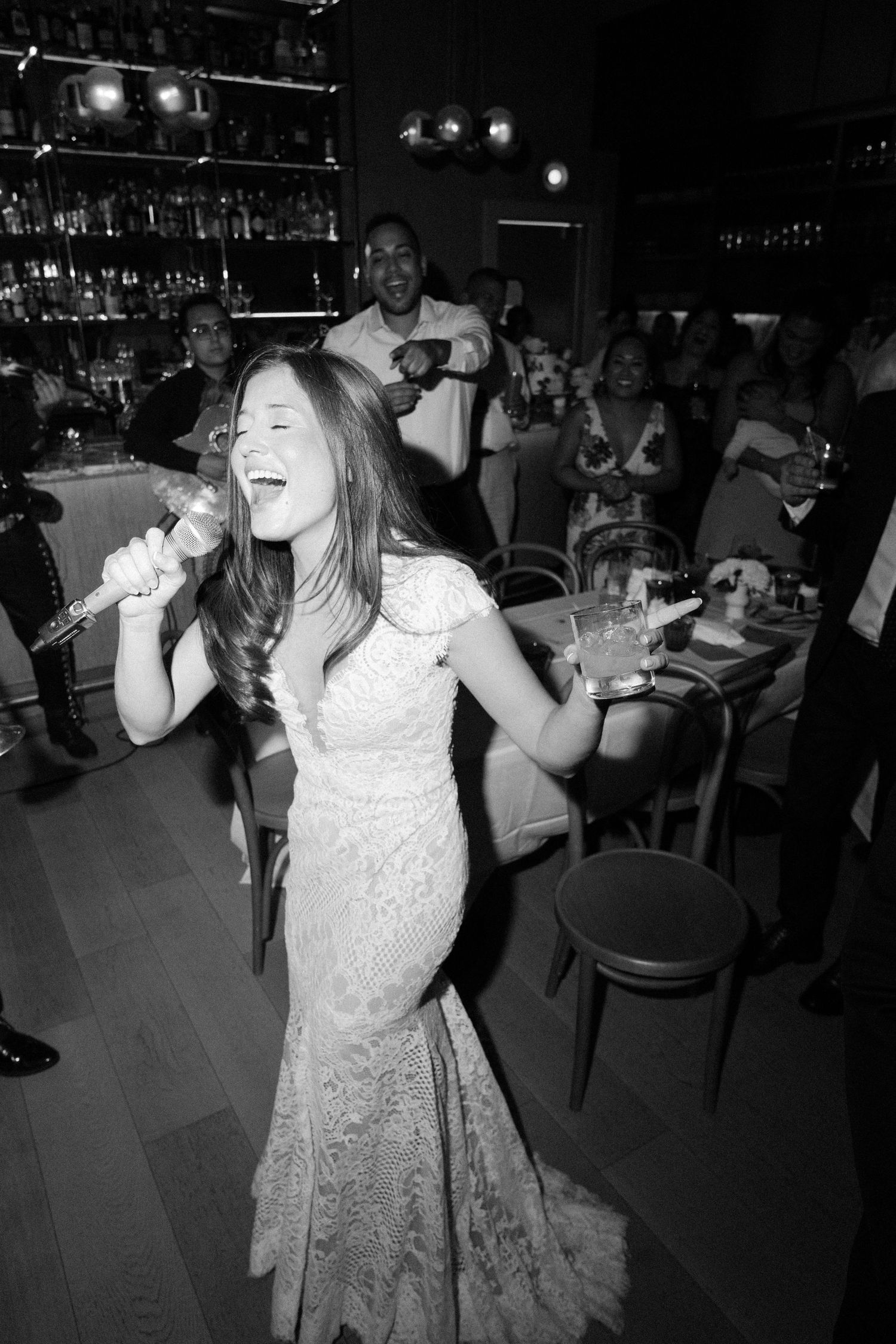 A lively dance party scene in a dimly lit bar or club with people enjoying themselves on the dance floor.
