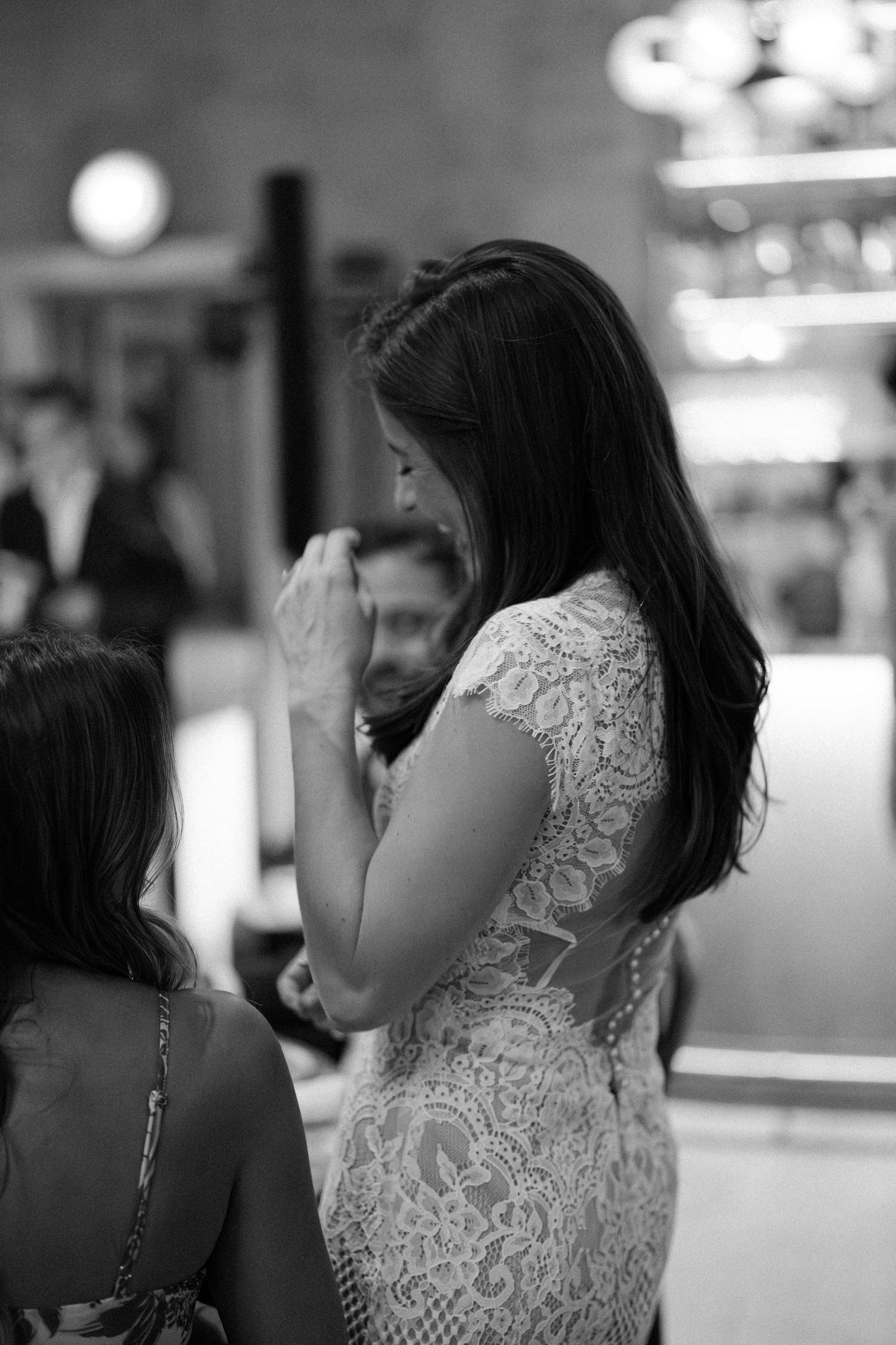 Black and white series showing guests in formal attire at an evening event.