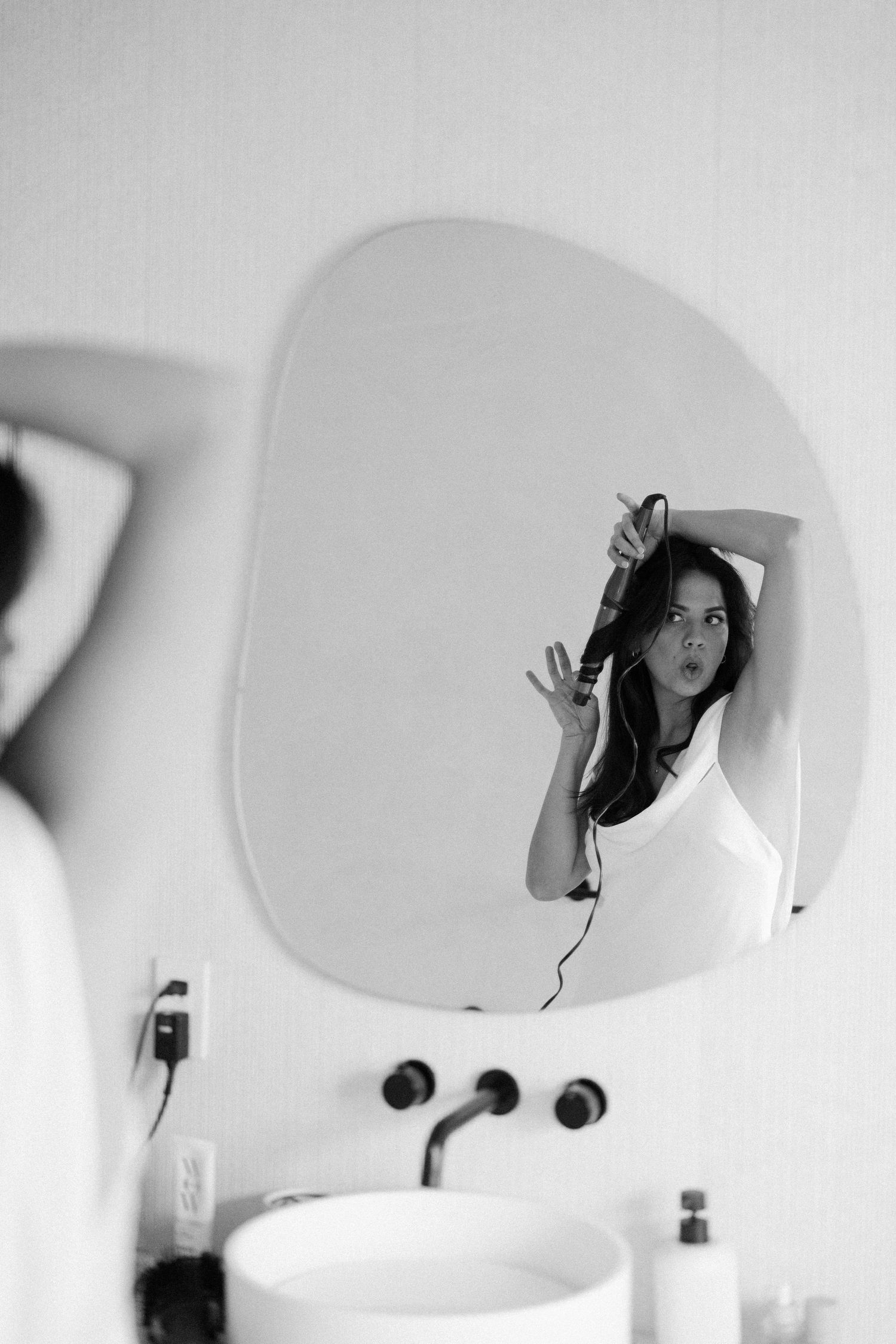 Series of mirror reflections showing artistic self-portraits in black and white.