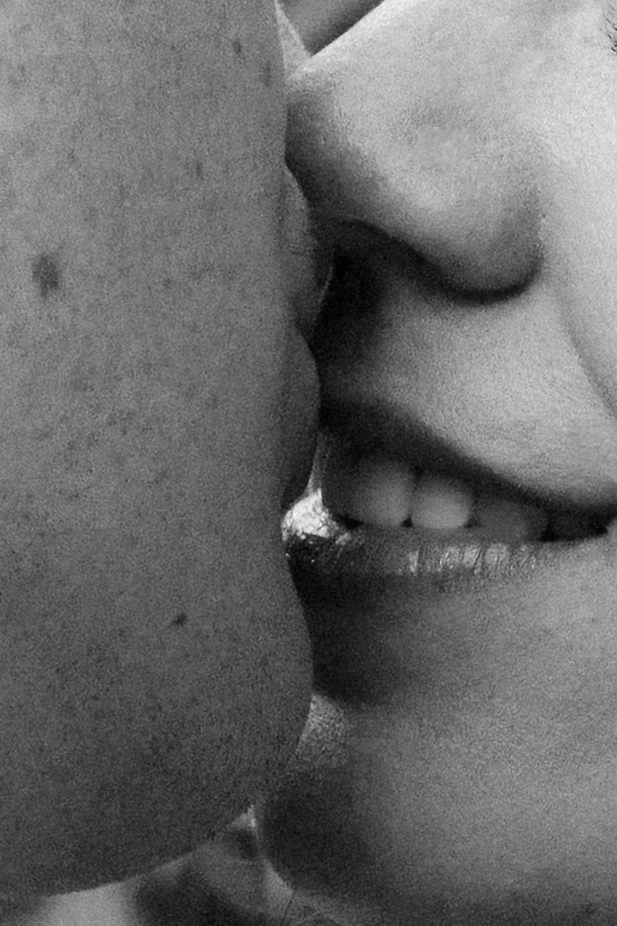 Close-up black and white photo showing a progression of lips with smoke coming from a cigarette.