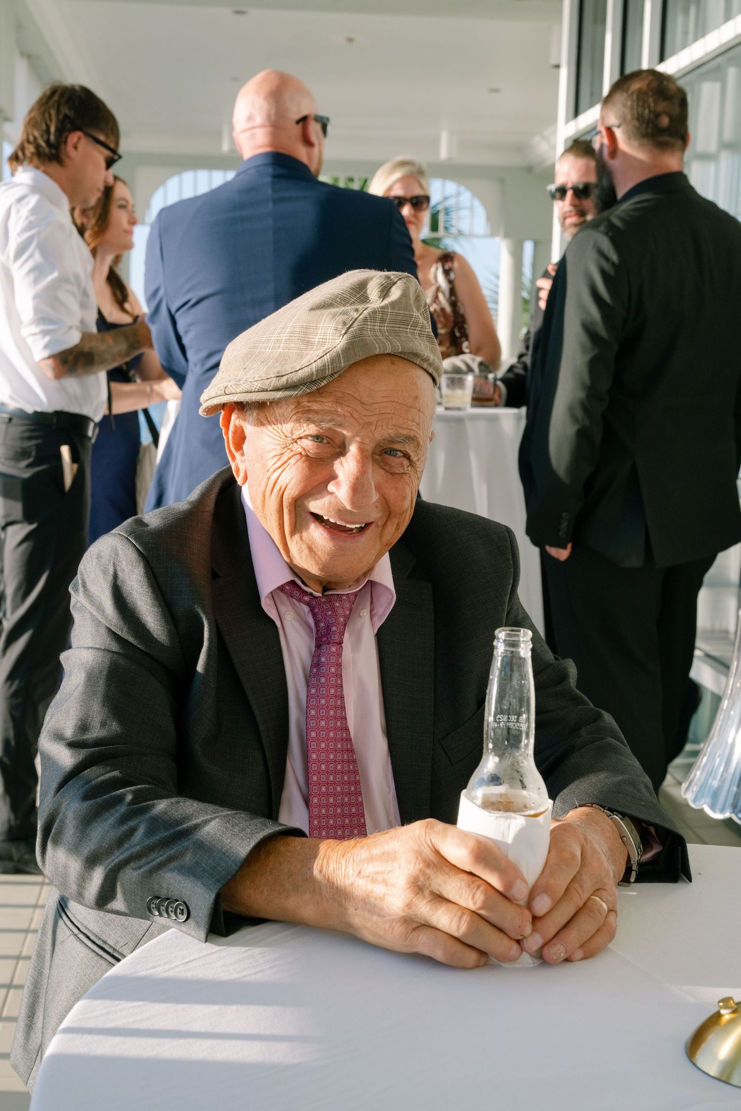 Guest in casual attire enjoying conversation at a formal event.