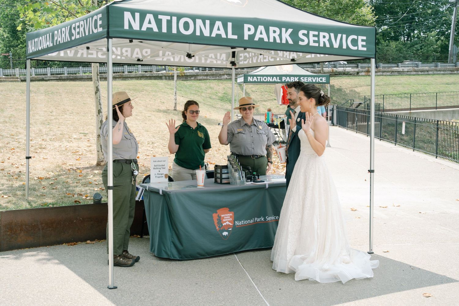 National Park Service signs visible at an outdoor wedding venue with stone architecture.