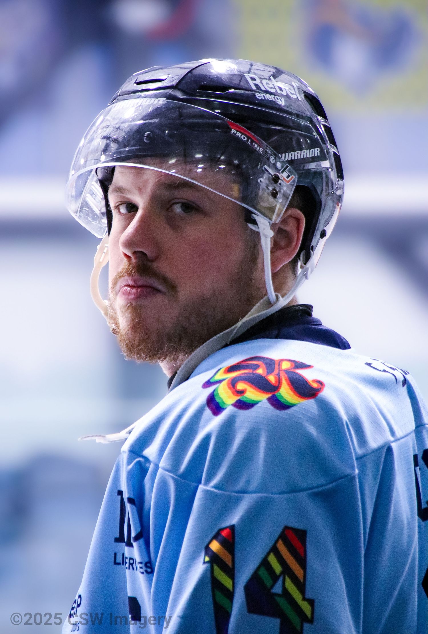 Hockey player in light blue jersey with rainbow numbers shown from multiple angles.