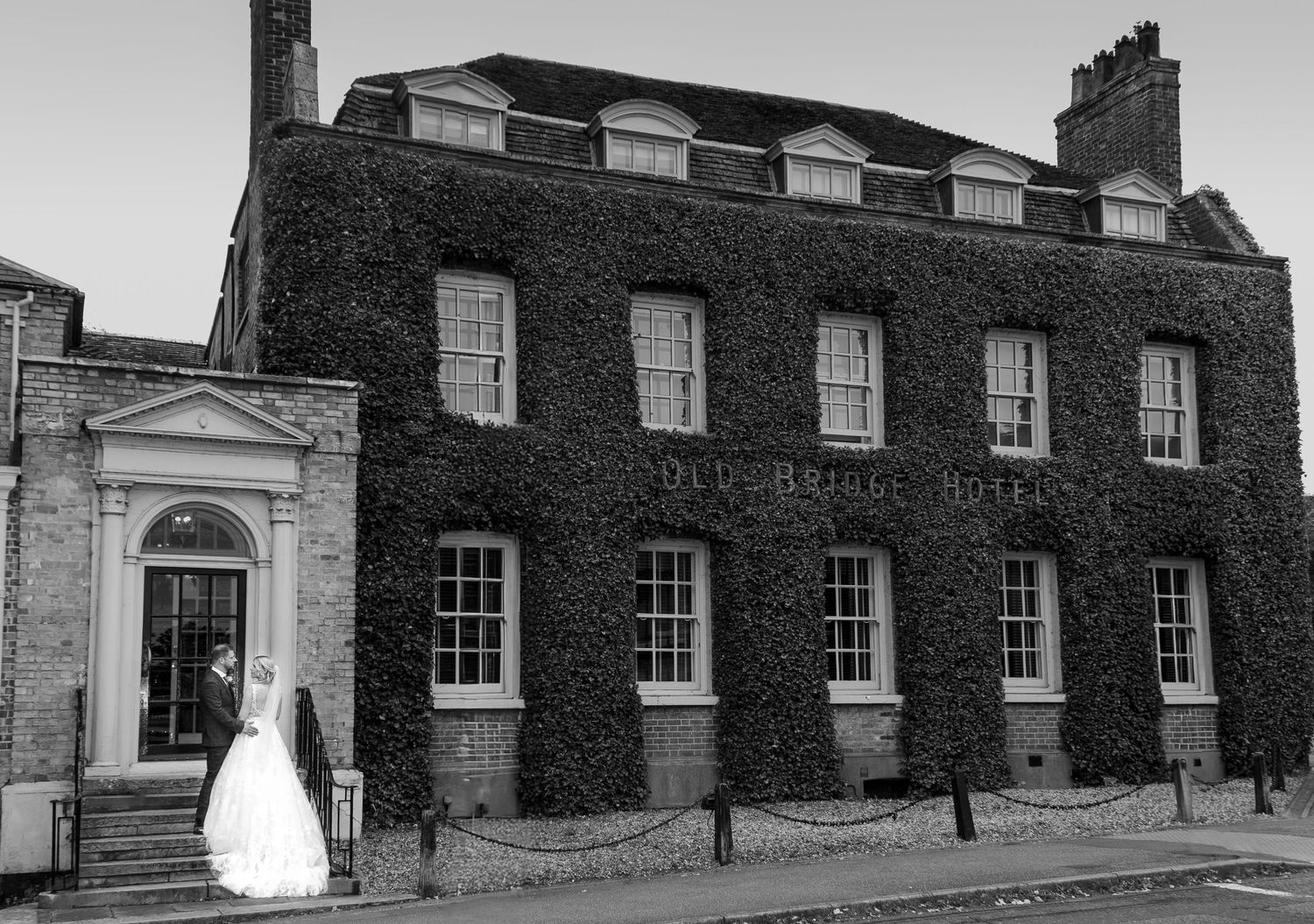 Row of historic black brick buildings with white trim windows and architectural details.