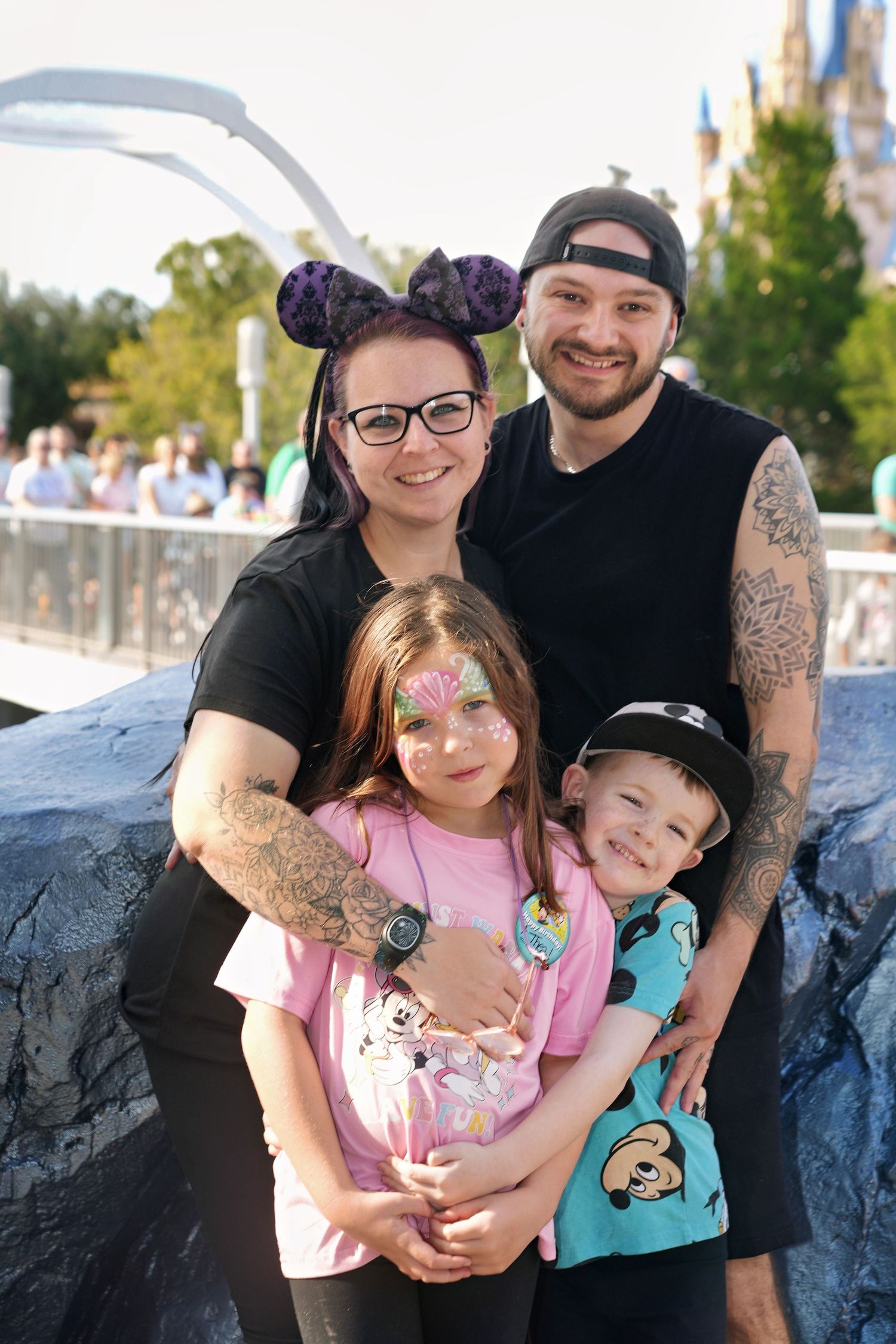 Family enjoying a fun day at Disney World with castle in background.