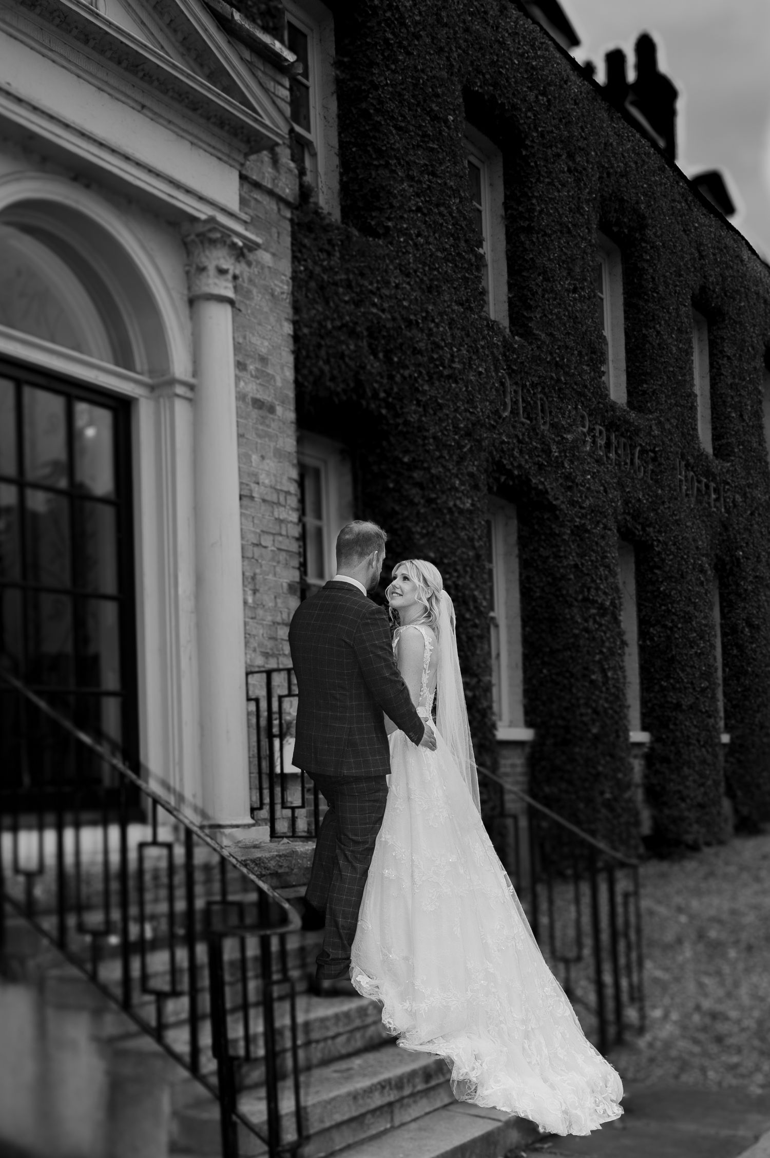 Black and white wedding photos showing a couple against an ivy-covered brick building facade.