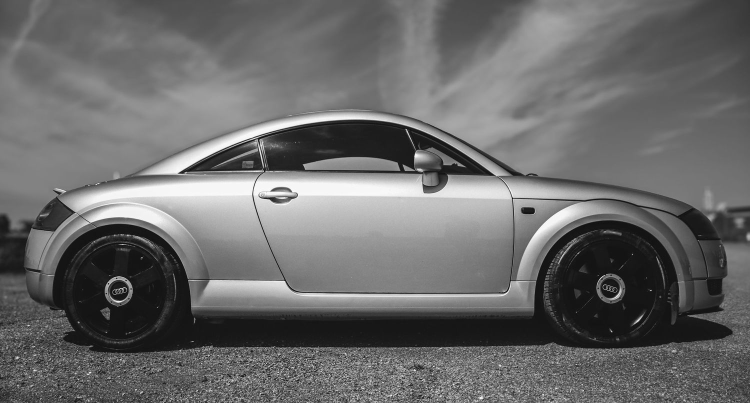 Sleek sports car silhouettes photographed in dramatic black and white.