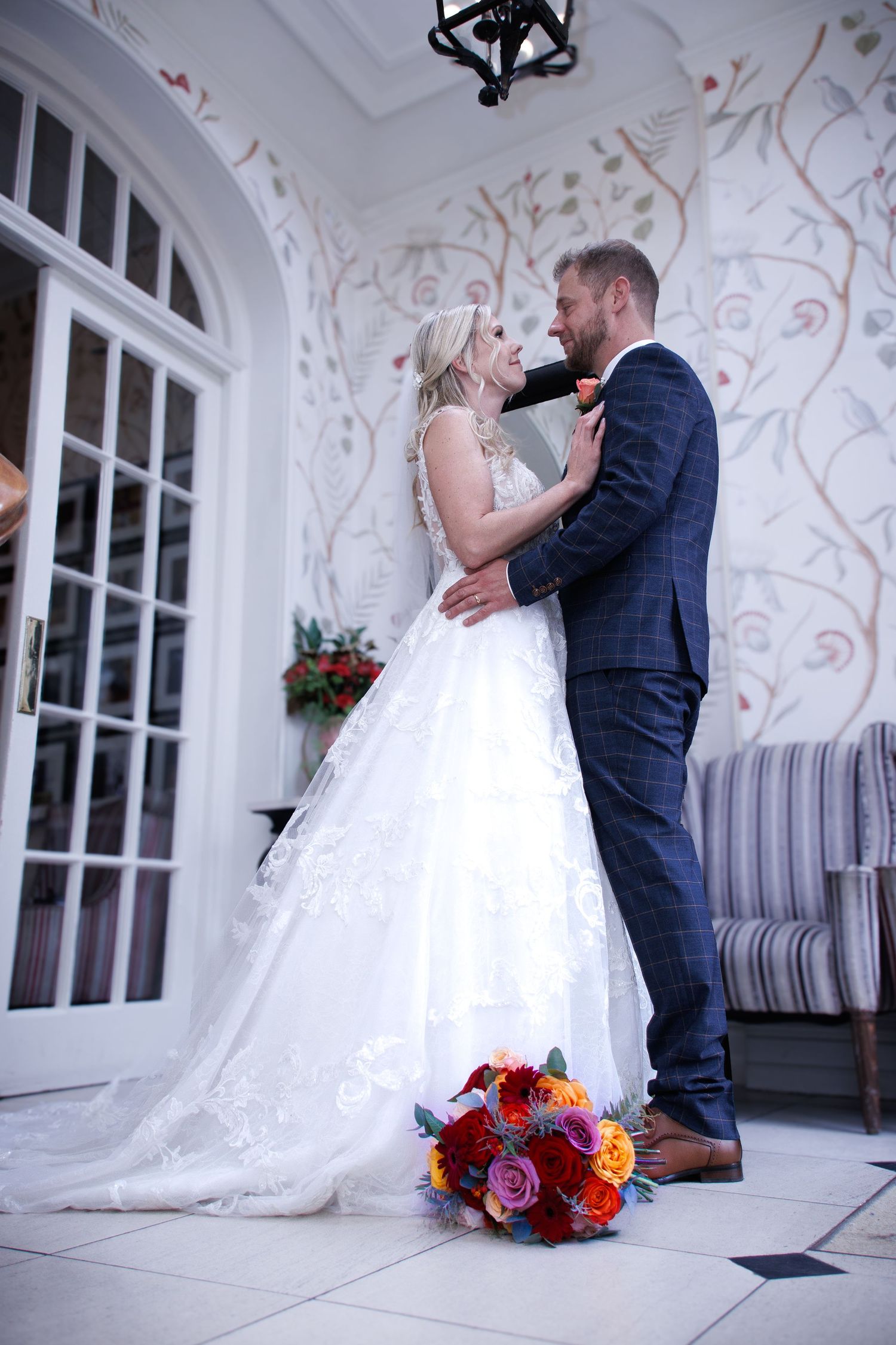 A romantic wedding moment captured in an elegantly decorated white room.