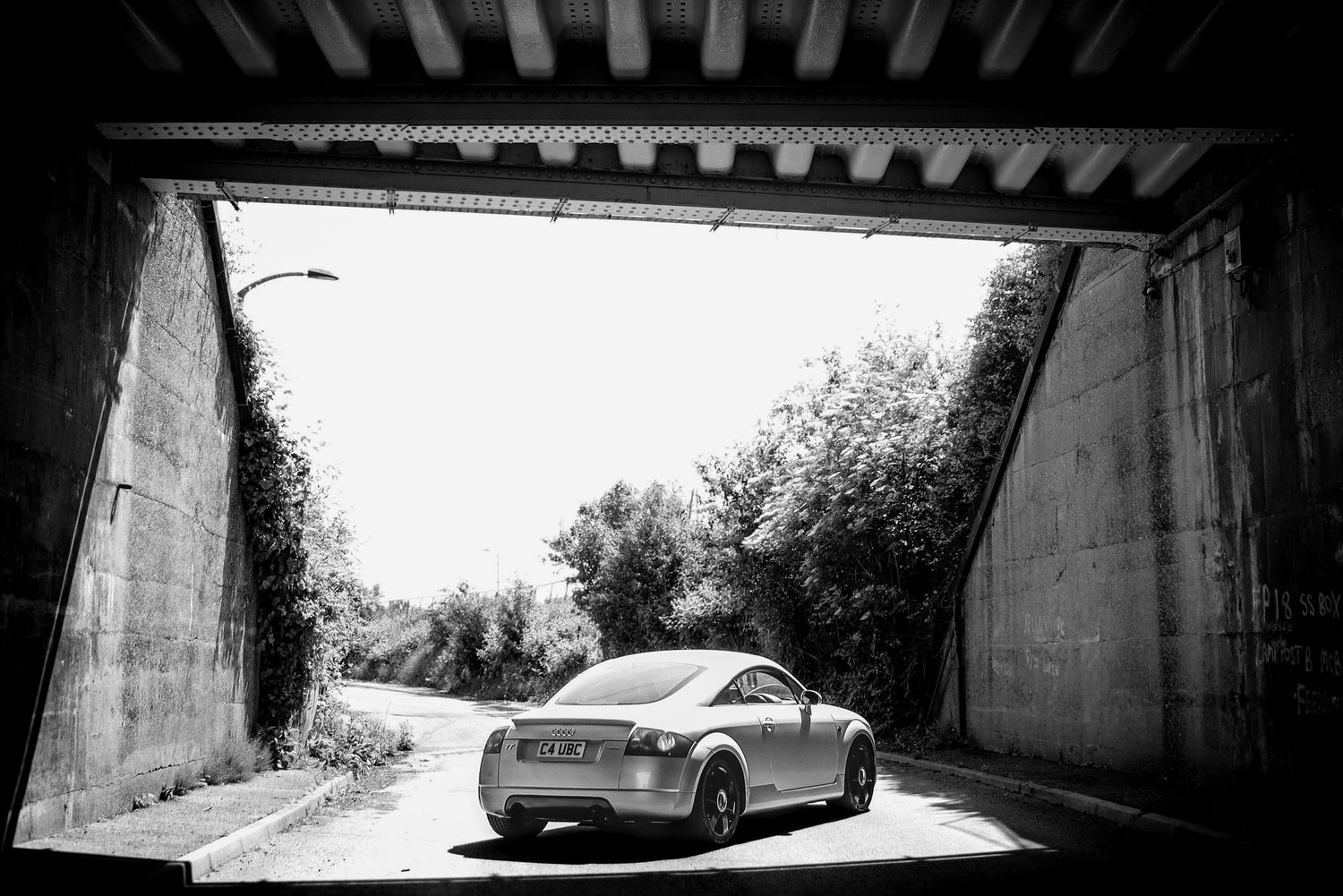 Dramatic black and white architectural photo of a bridge underpass.