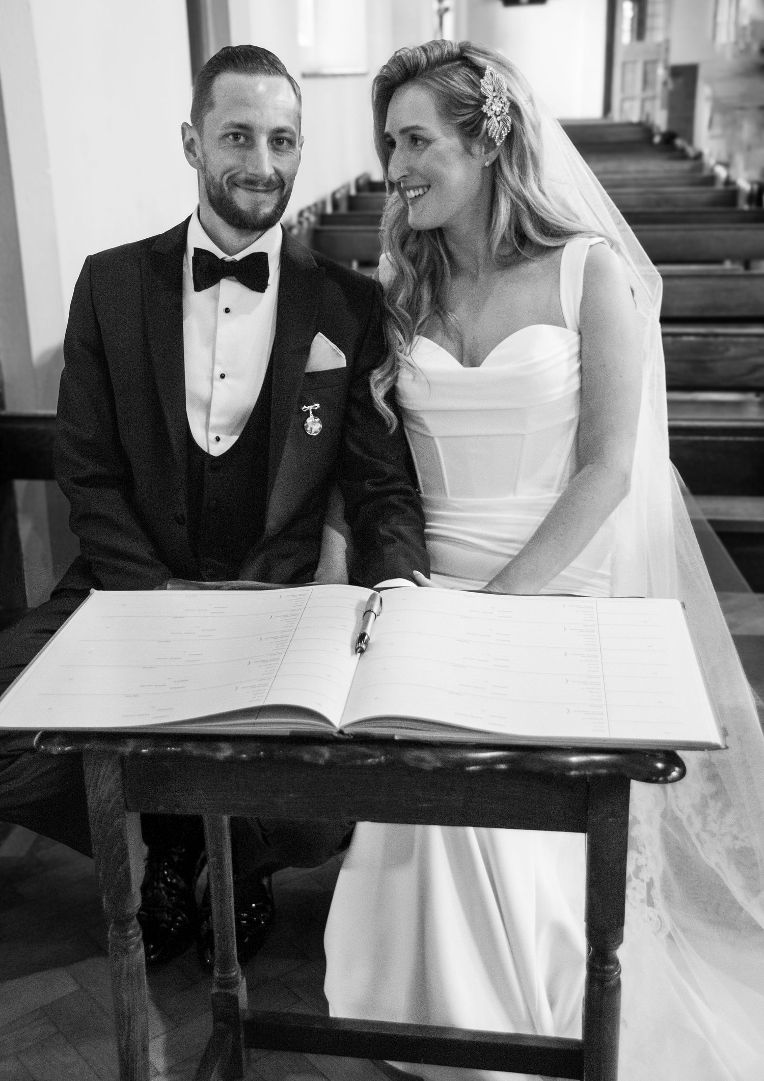 Elegant wedding ceremony in a church with couple signing the marriage register.