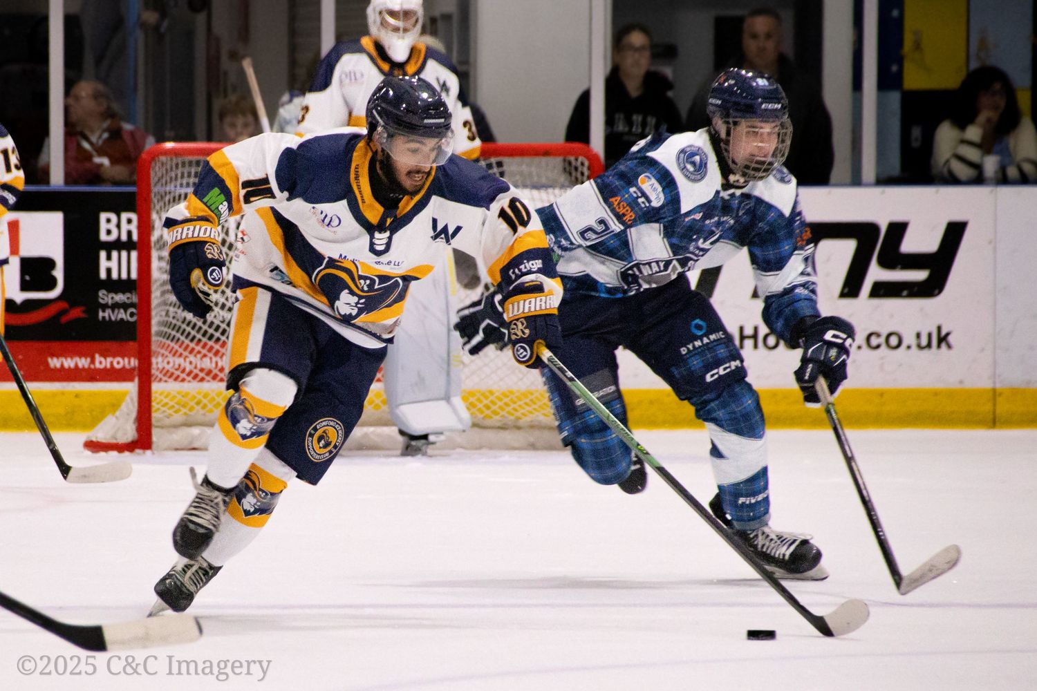 Ice hockey players battle for puck possession during an intense game.
