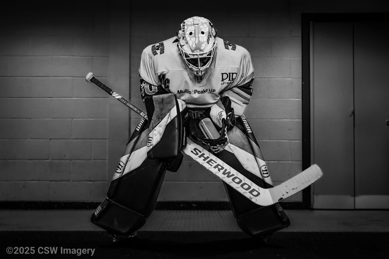 Black and white photo series of hockey goalies in dramatic lighting.