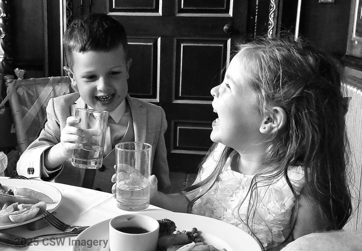 Children enjoying drinks and snacks at a casual restaurant gathering.