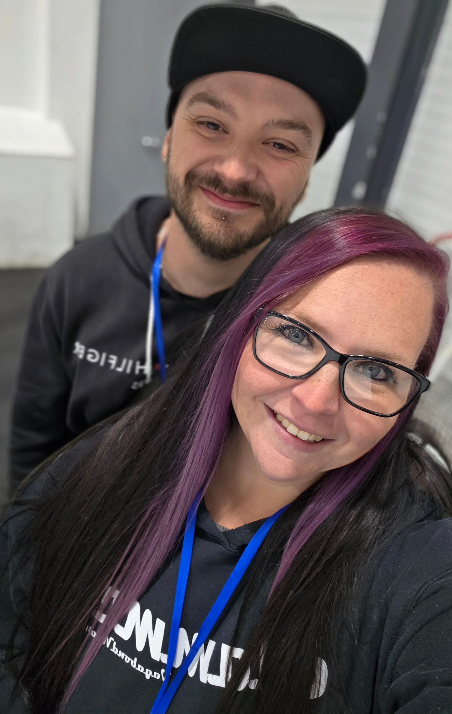 A couple takes a series of indoor selfies showing their smiling faces and casual attire.