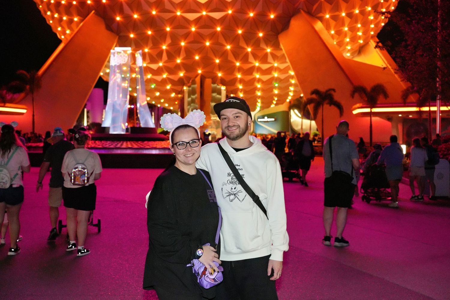 Theme park interior with orange dome lighting and pink ambient glow.