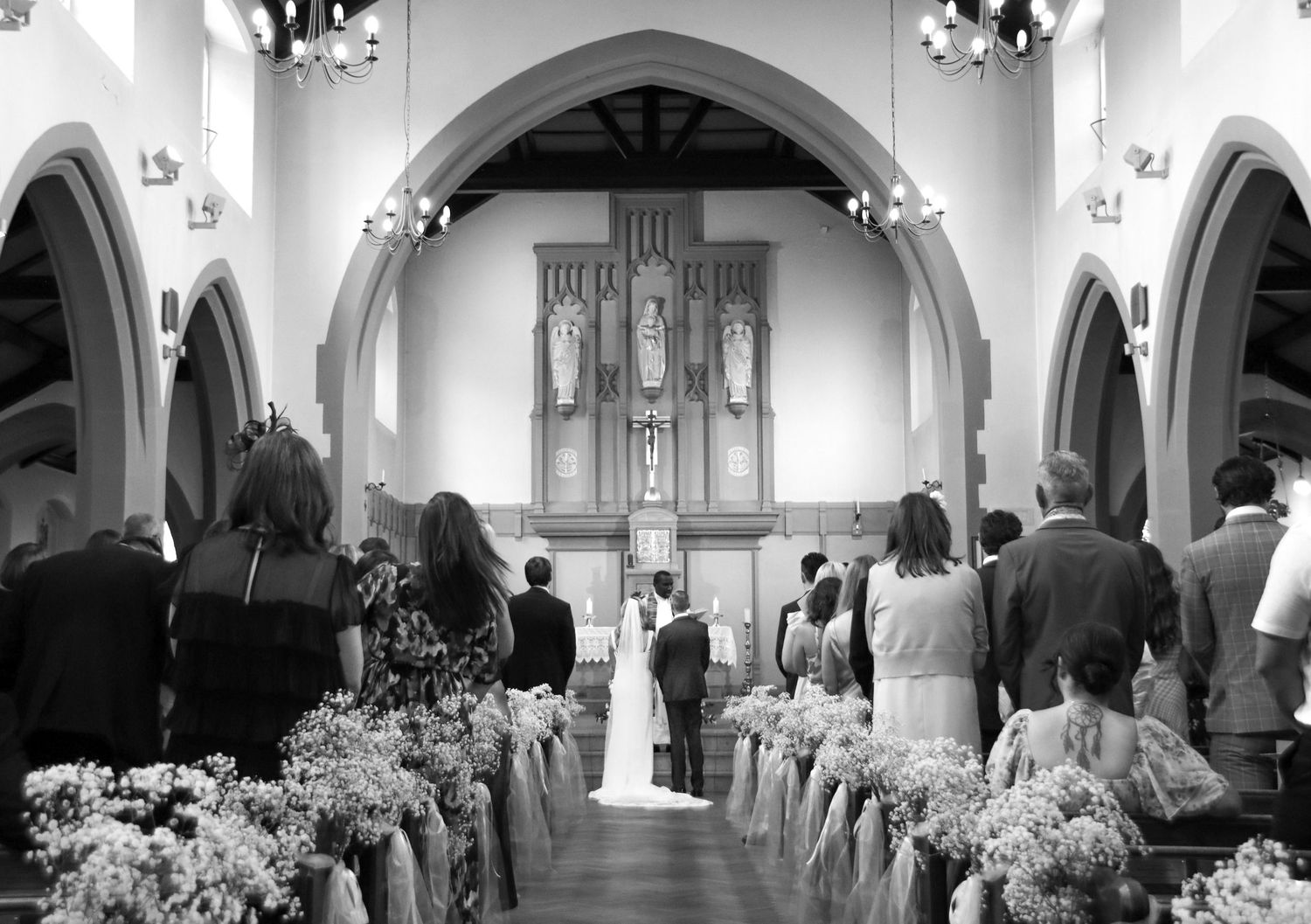 Black and white interior shots of a church with gothic arches and floral decorations.