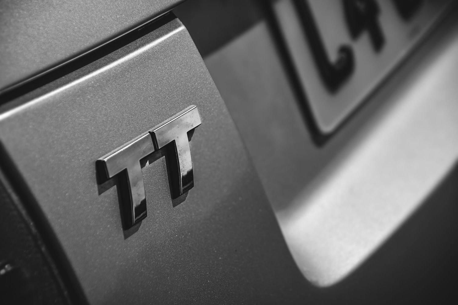 Abstract black and white macro shots of metallic surfaces with numbers.