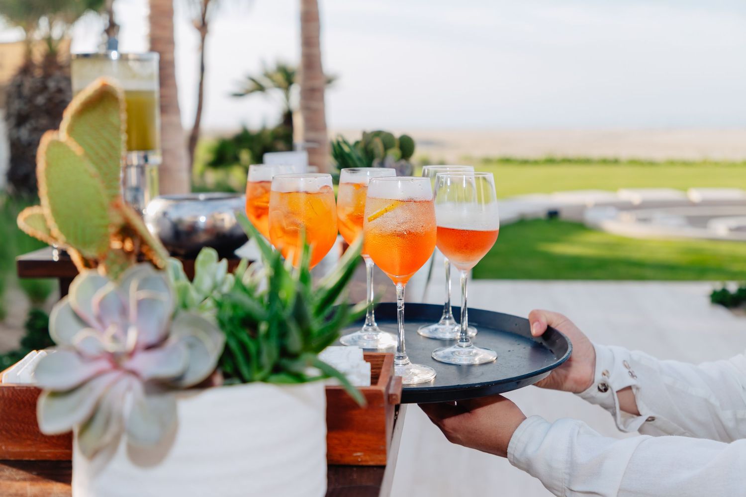 Elegant outdoor dining setup with wine glasses and ocean views.