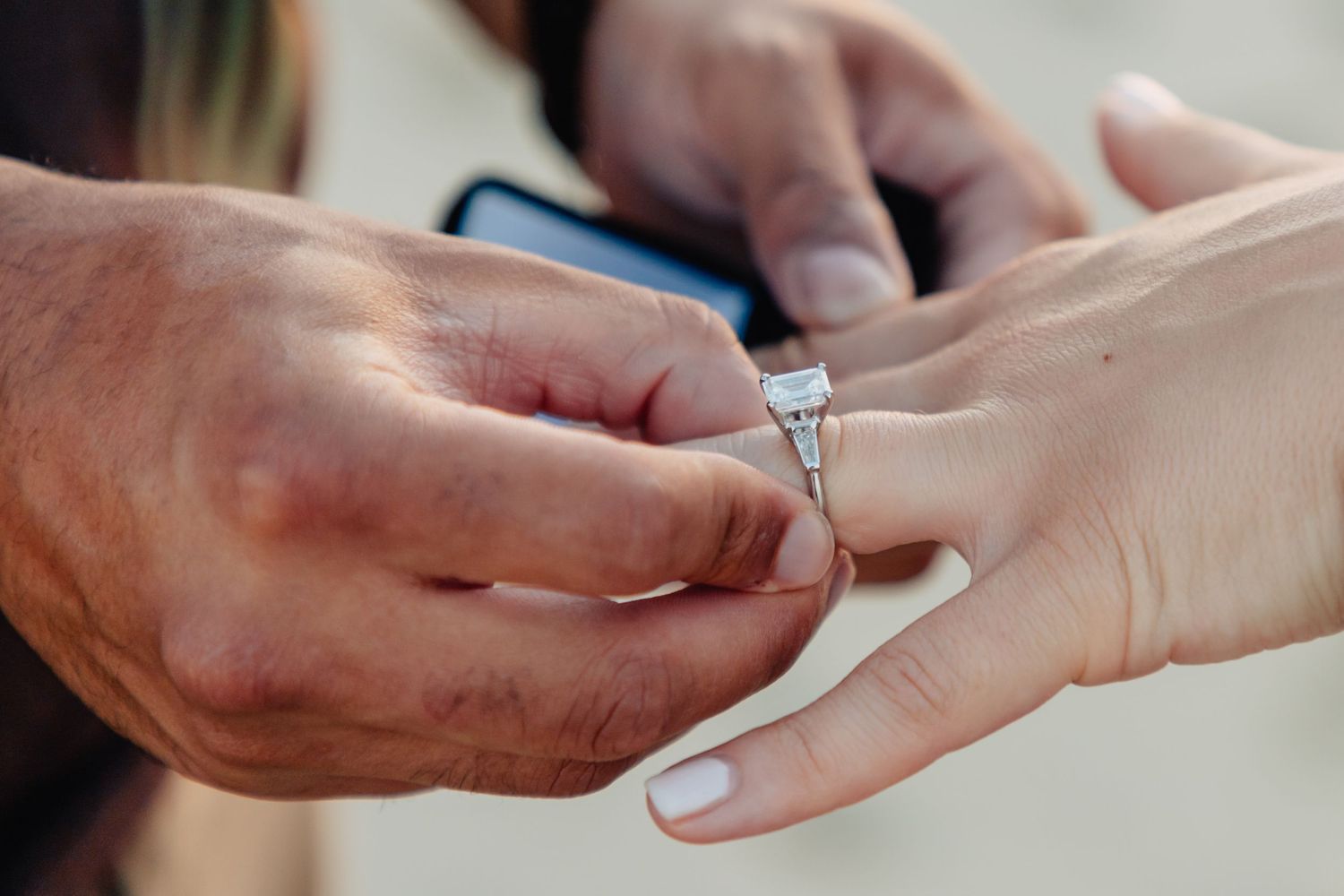 A series of hands exchanging engagement rings in various romantic proposal moments.