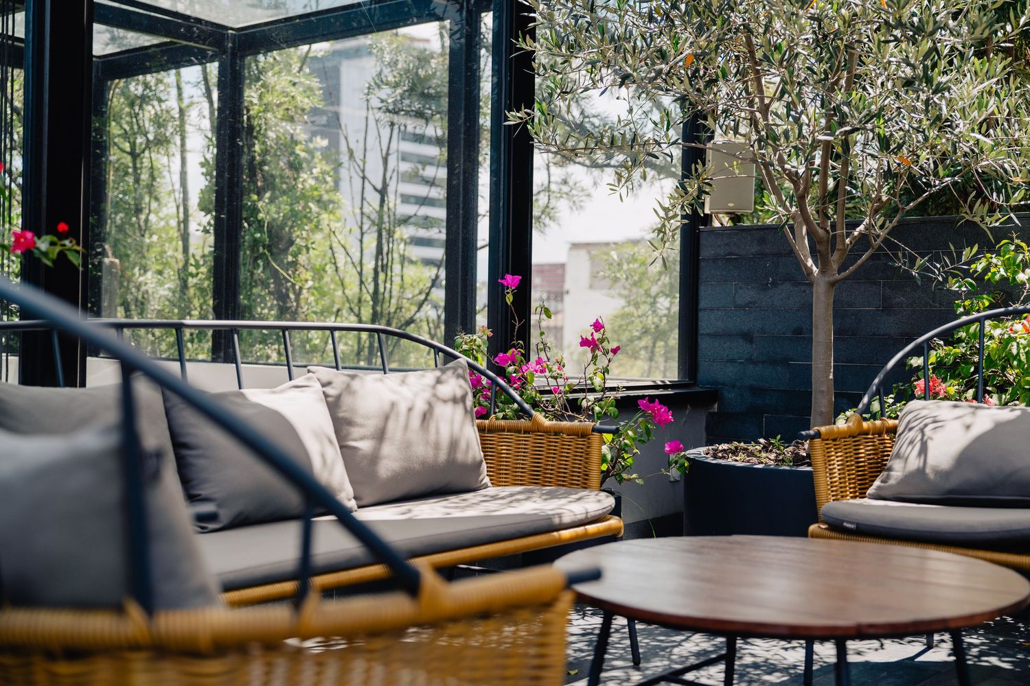 Modern restaurant interior features floor-to-ceiling windows, natural light, and comfortable seating arrangements.