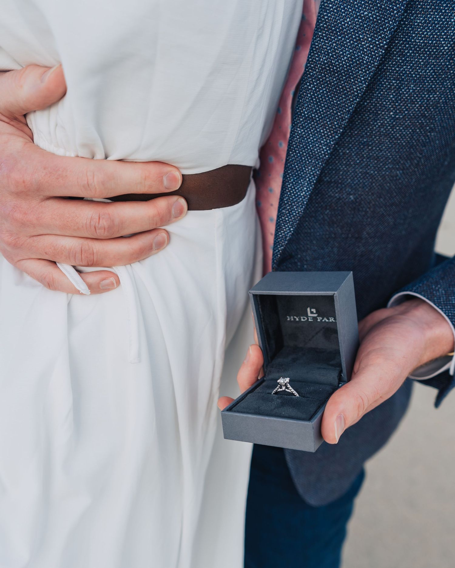 Close-up shots of an engagement ring being presented in a dark box.