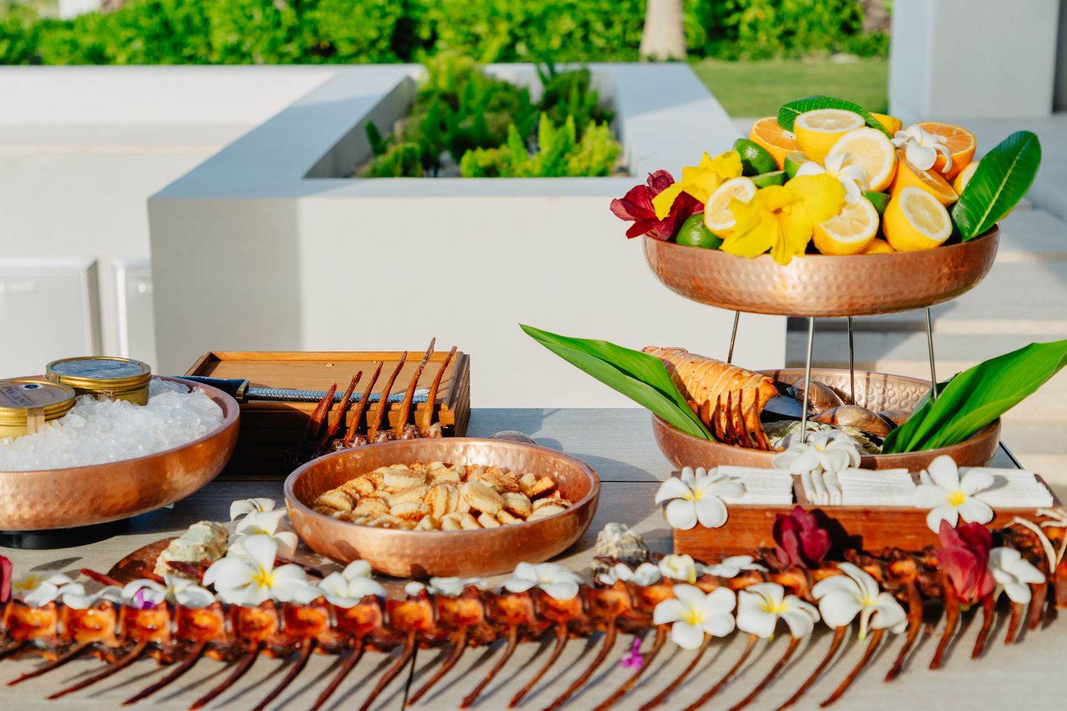 Elegant catering display of appetizers and hors d'oeuvres arranged on wooden serving boards.