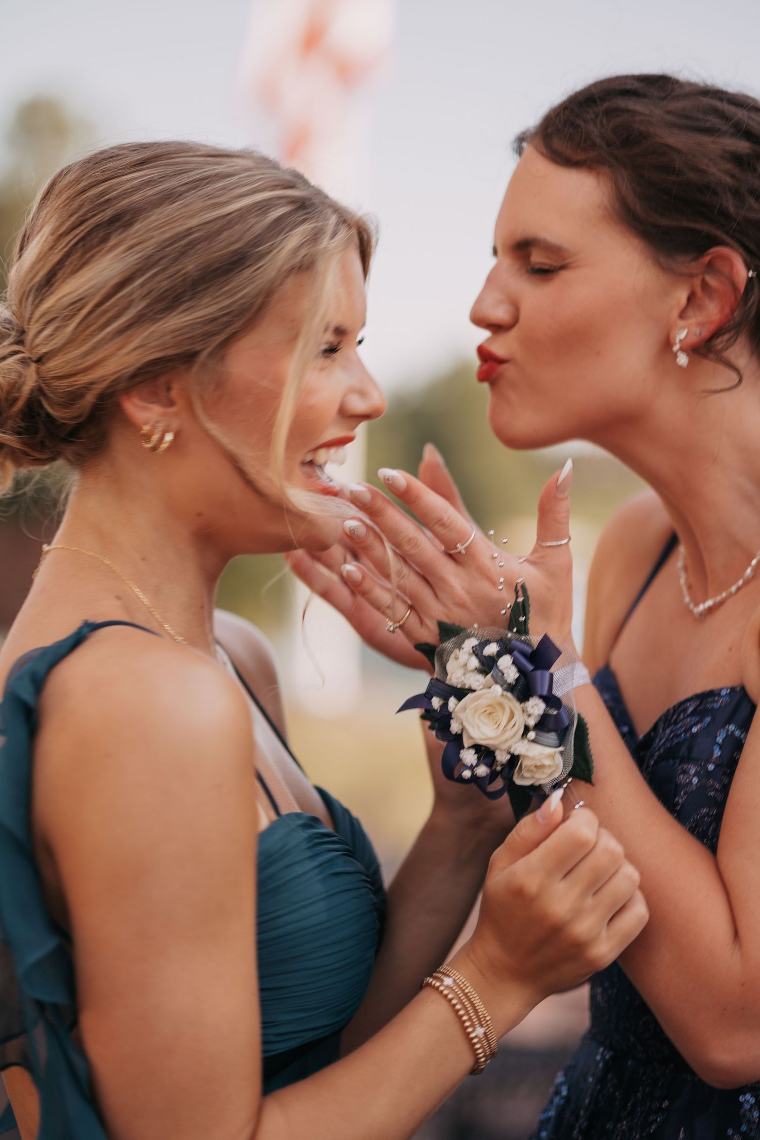 Photo of 2 best friends sharing a silly moment on prom day.