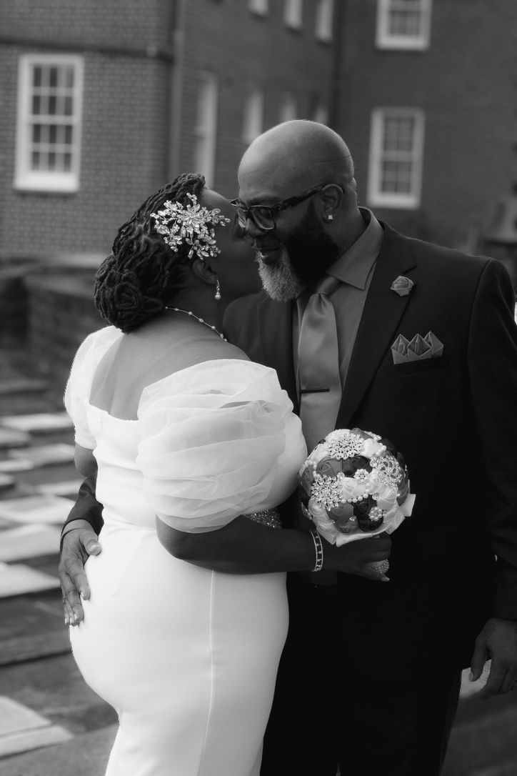 This shows a photo of a newly married couple sharing an intimate moment on their day.