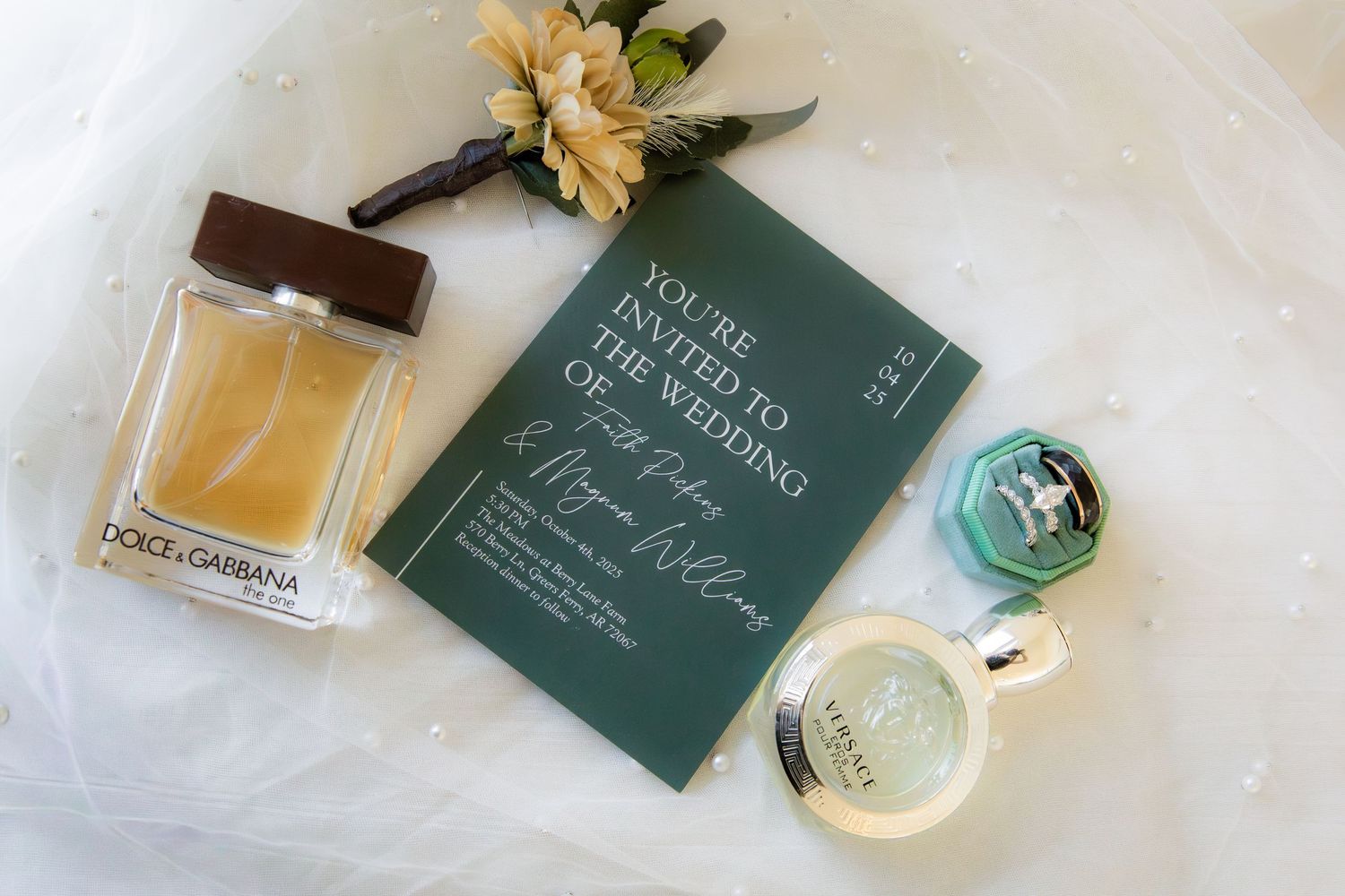 Detail shot of perfume wedding invite boutonniere and wedding rings