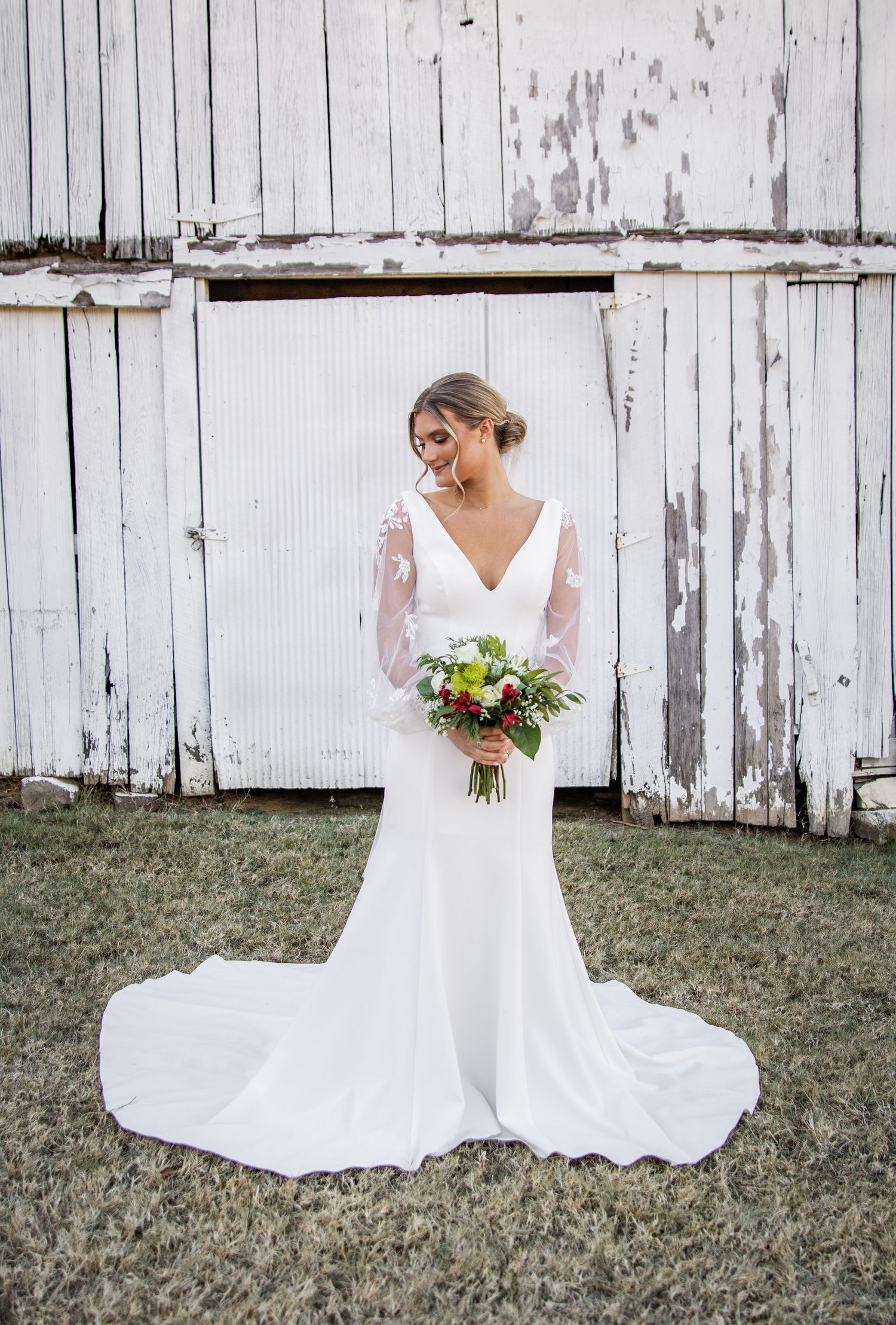 Bride holding flowers and smiling and looking down