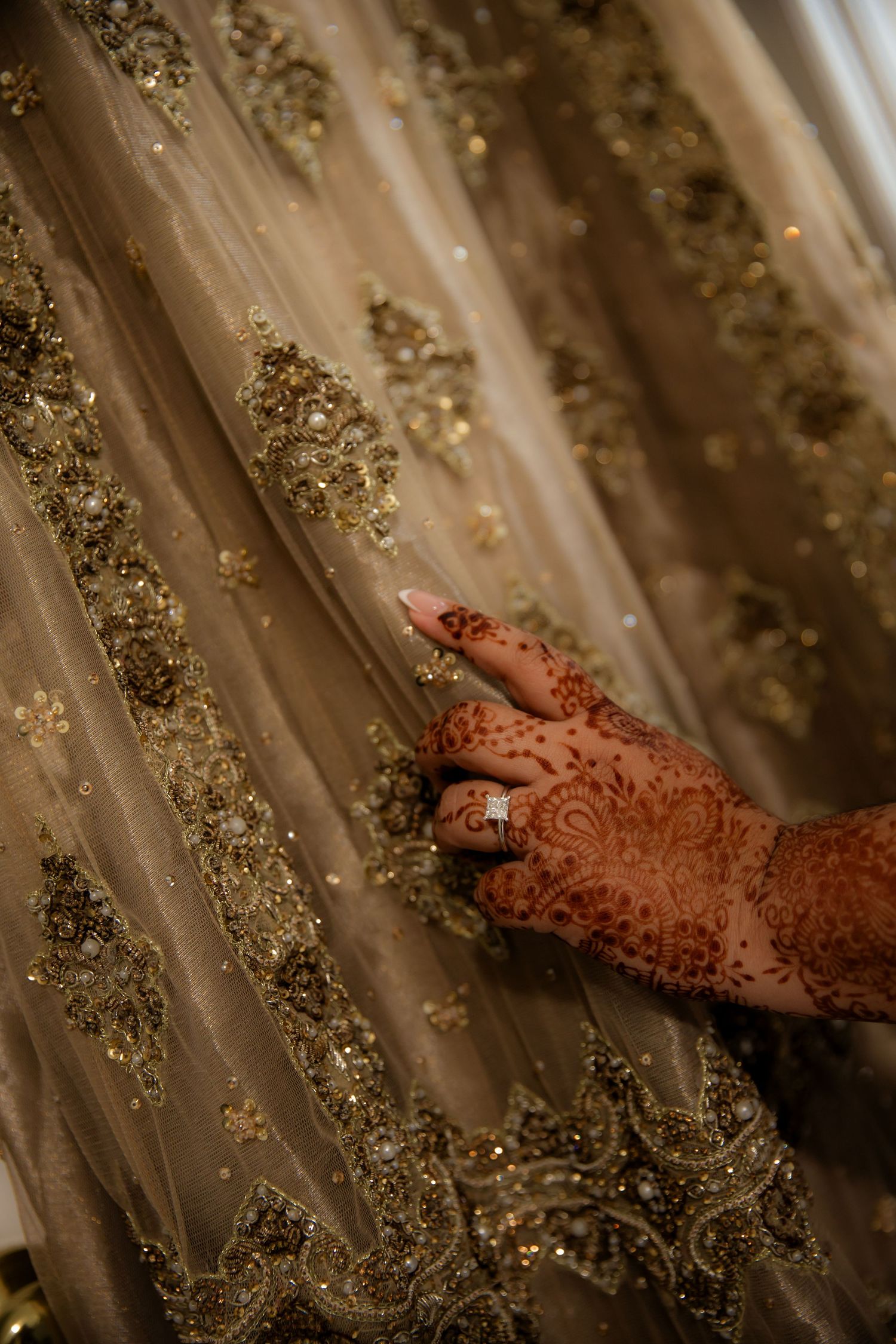 Holding dress and admiring with engagement ring