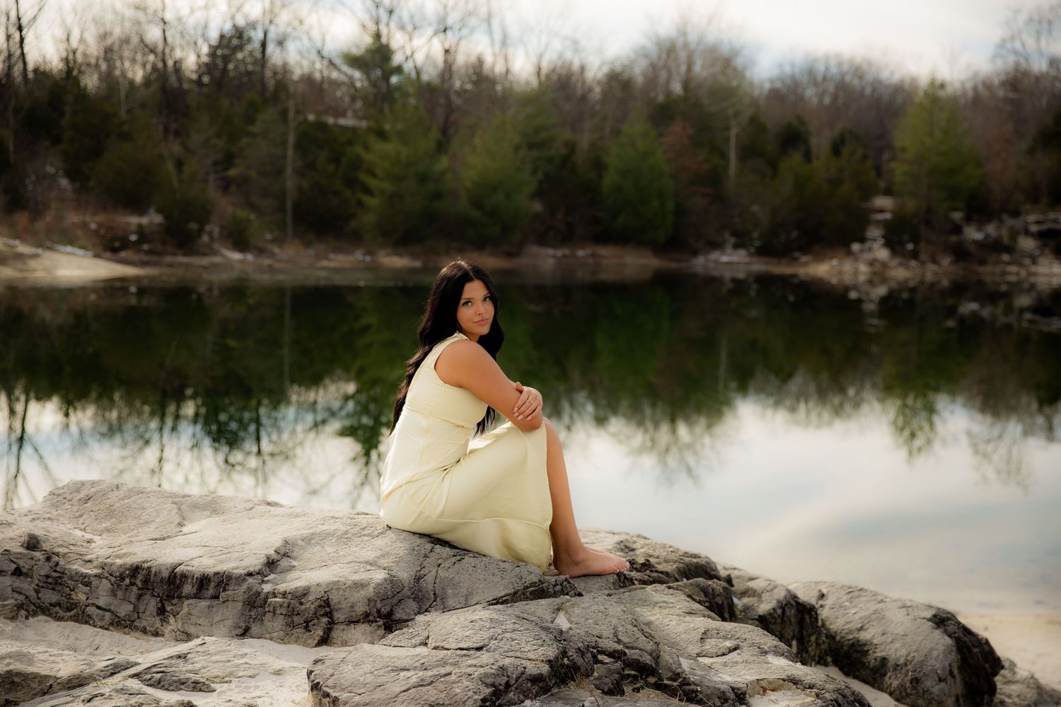 Girl in yellow dress with reflection of water behind her