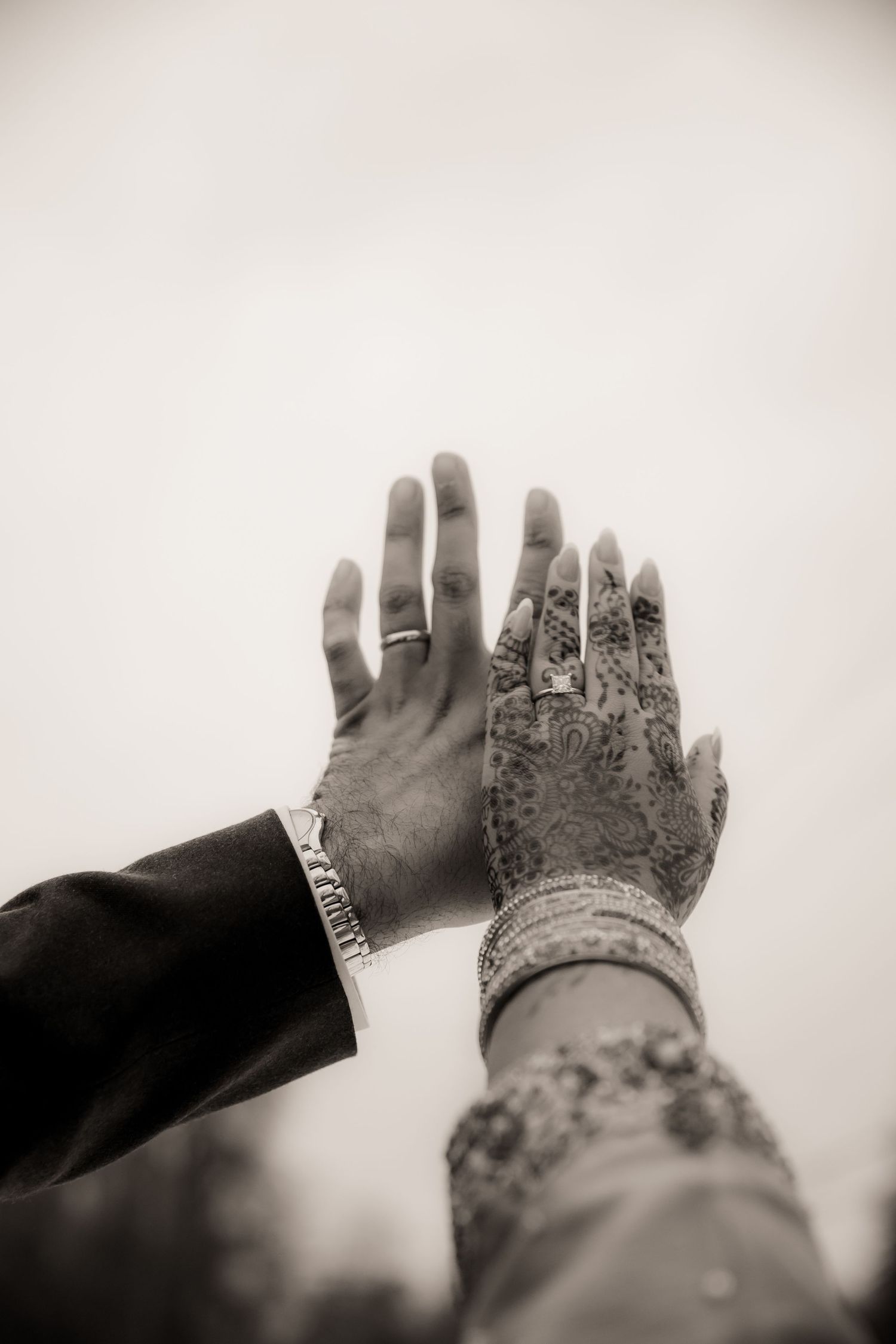 Hands in the air highlighting wedding rings